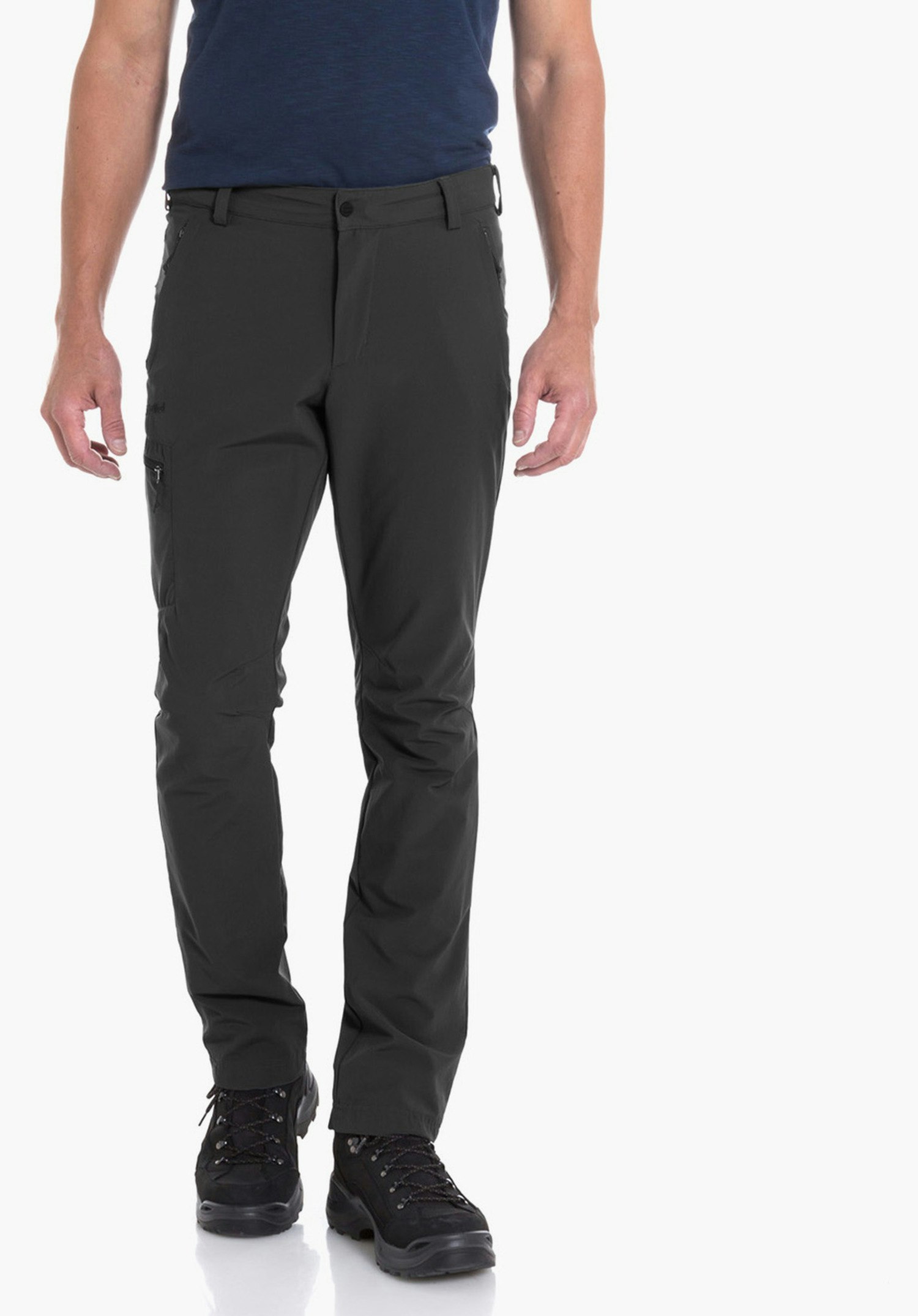 Pants Folkstone Man wears a dark blue T-shirt with mountain graphic and the text “Schöffel”, stands relaxed, looks to the right; wears dark green trousers and black hiking shoes, white studio background.