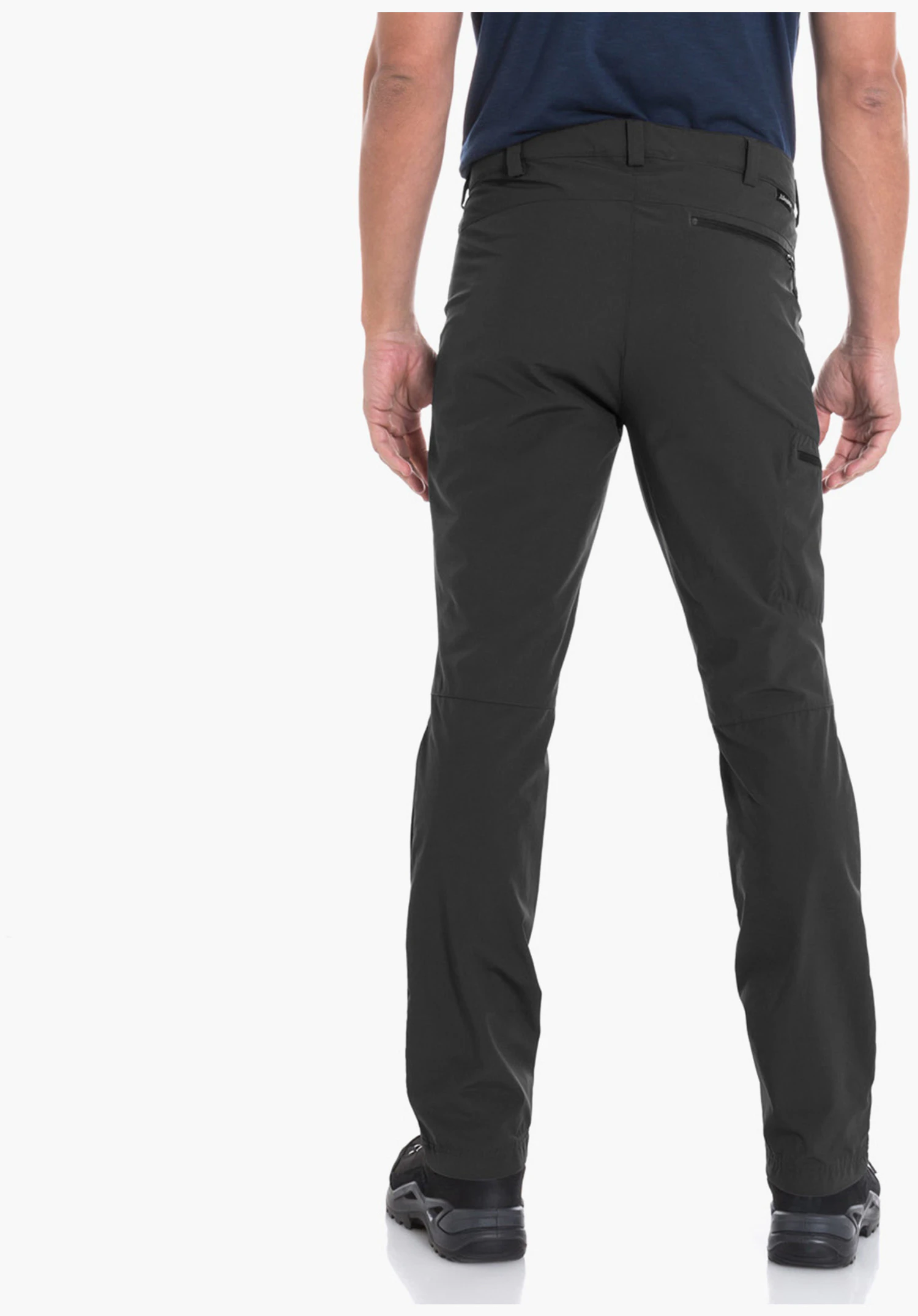 Pants Folkstone man standing with his back to the camera, looking slightly left; wearing a dark blue T-shirt, dark green trousers and black shoes; white studio background.