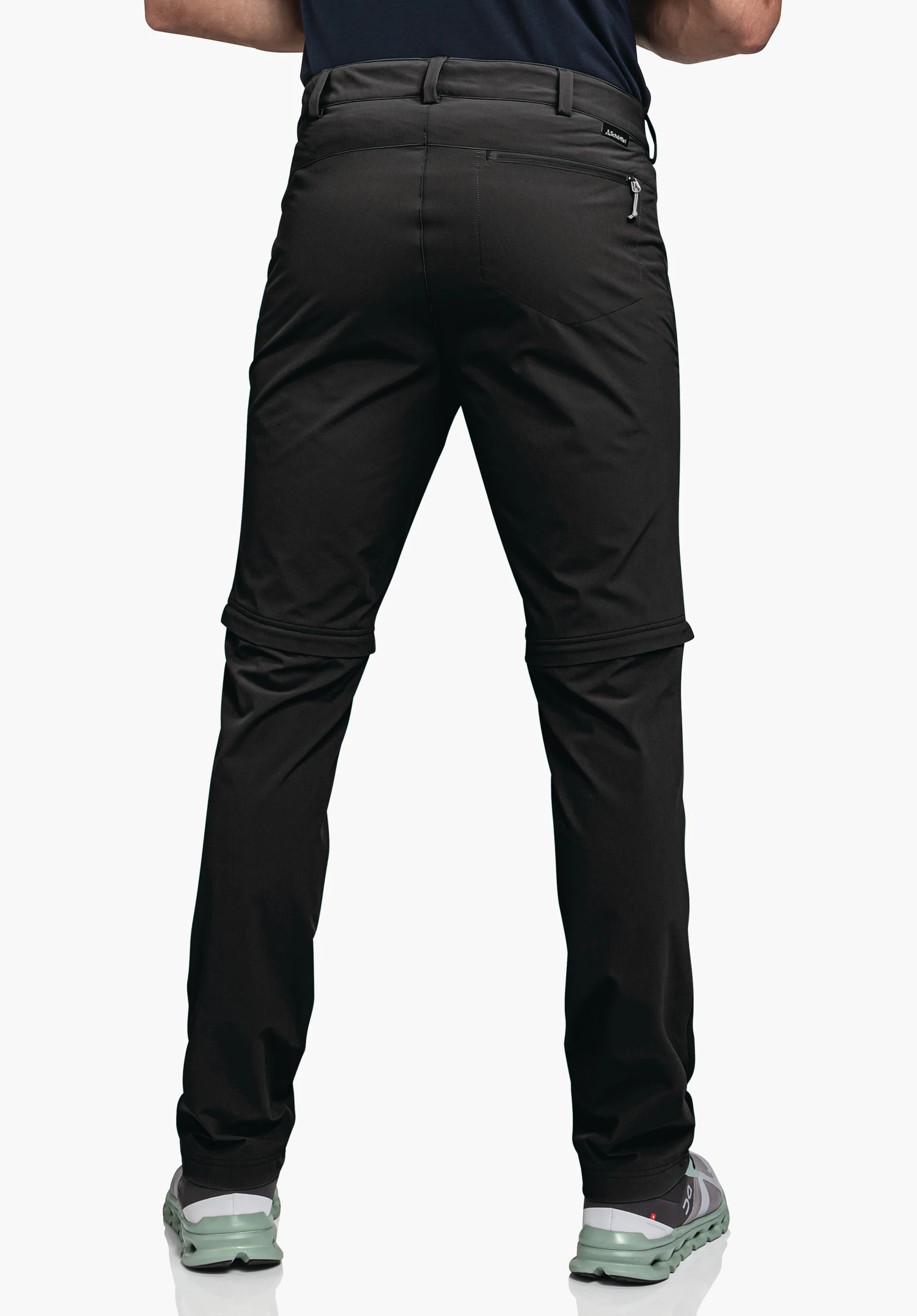 Pants Folkstone Zip Off en schwarz, présentés en vue de dos sur un mannequin sur fond neutre, avec le logo Schöffel visible à la taille.