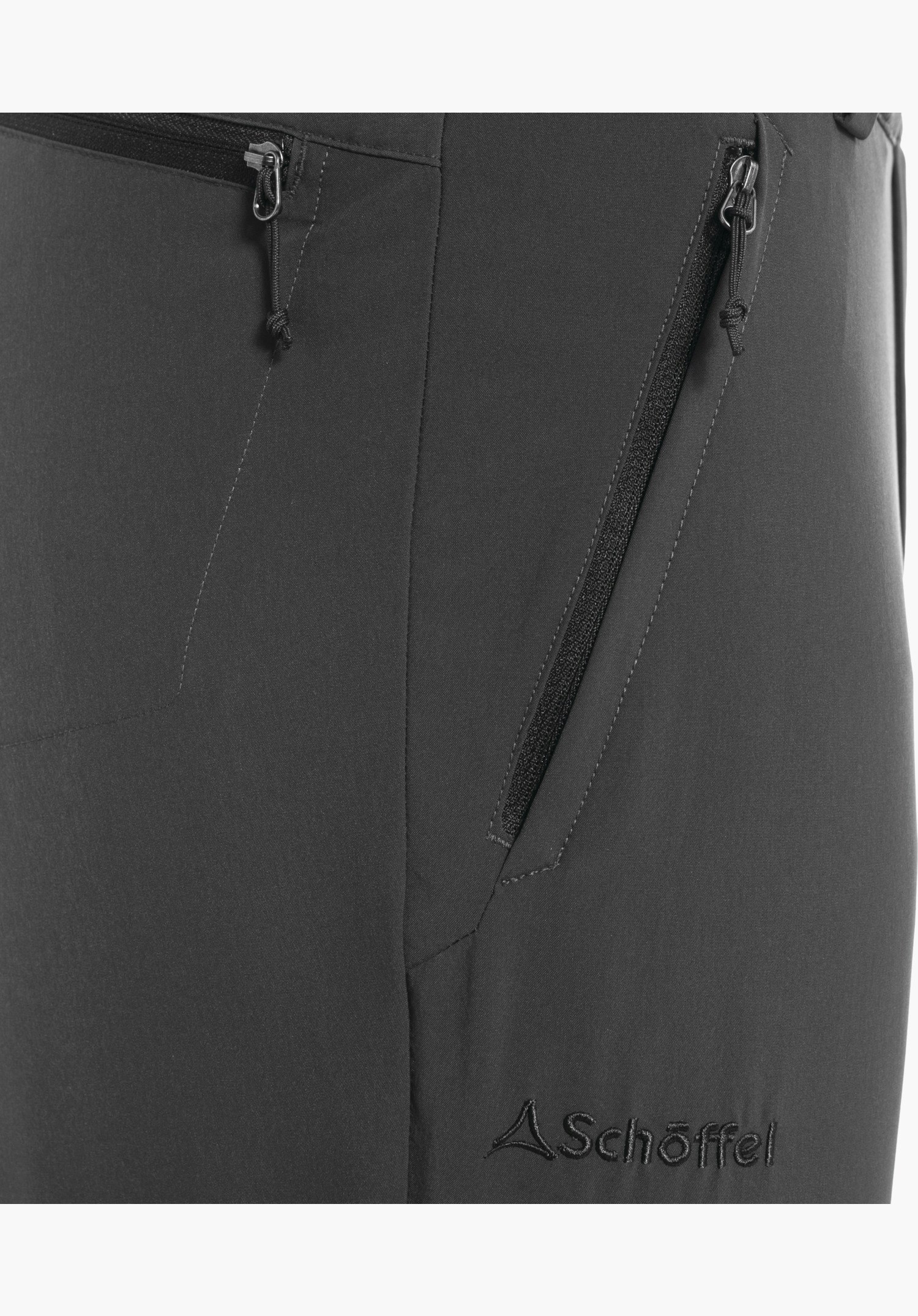Pants Folkstone Zip Off, detail view of the zip pocket and the embroidered Schöffel logo on the grey fabric, close-up against a white/neutral background.