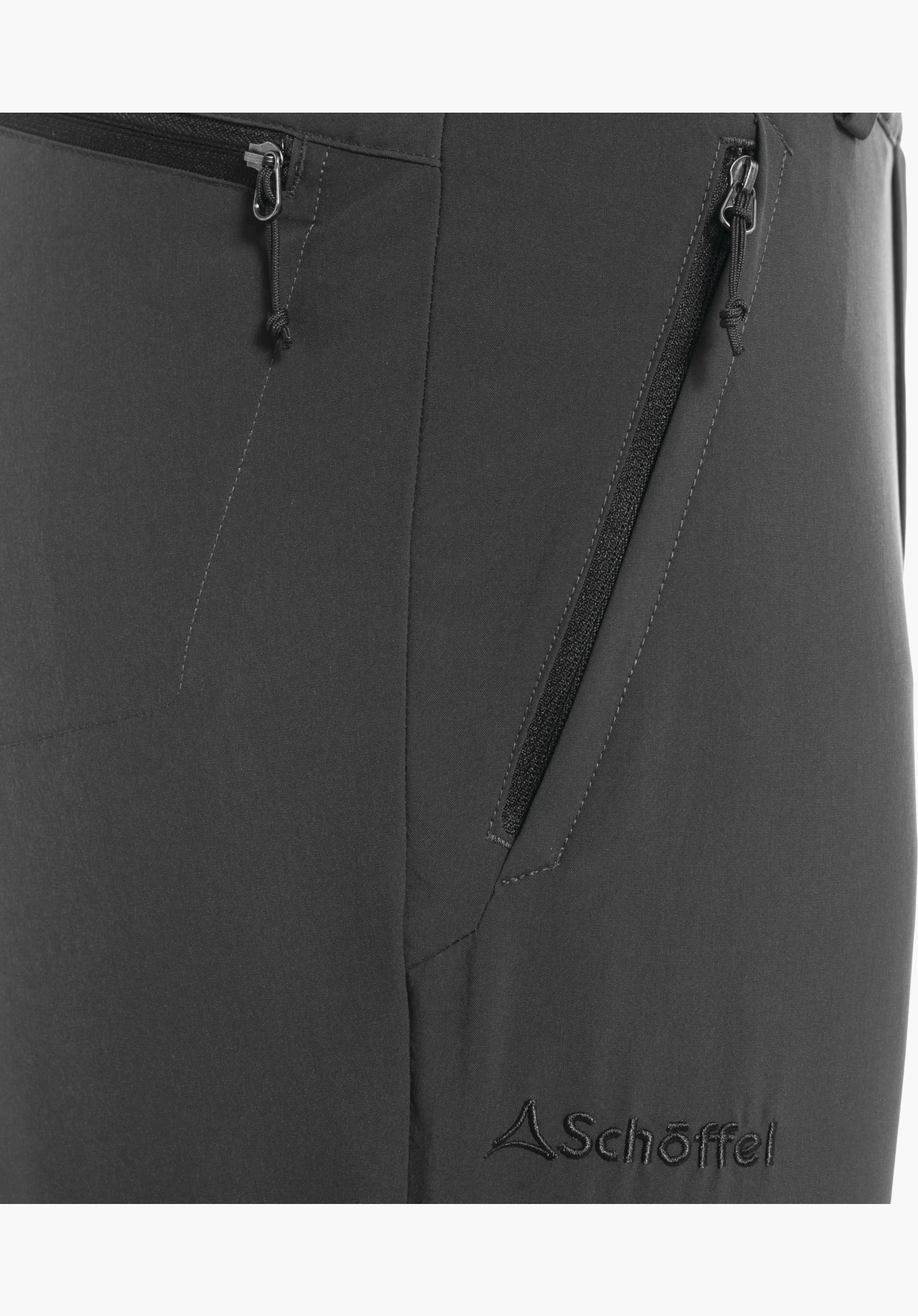 Pants Folkstone Zip Off, detail view of the zip pocket and the embroidered Schöffel logo on the grey fabric, close-up against a white/neutral background.