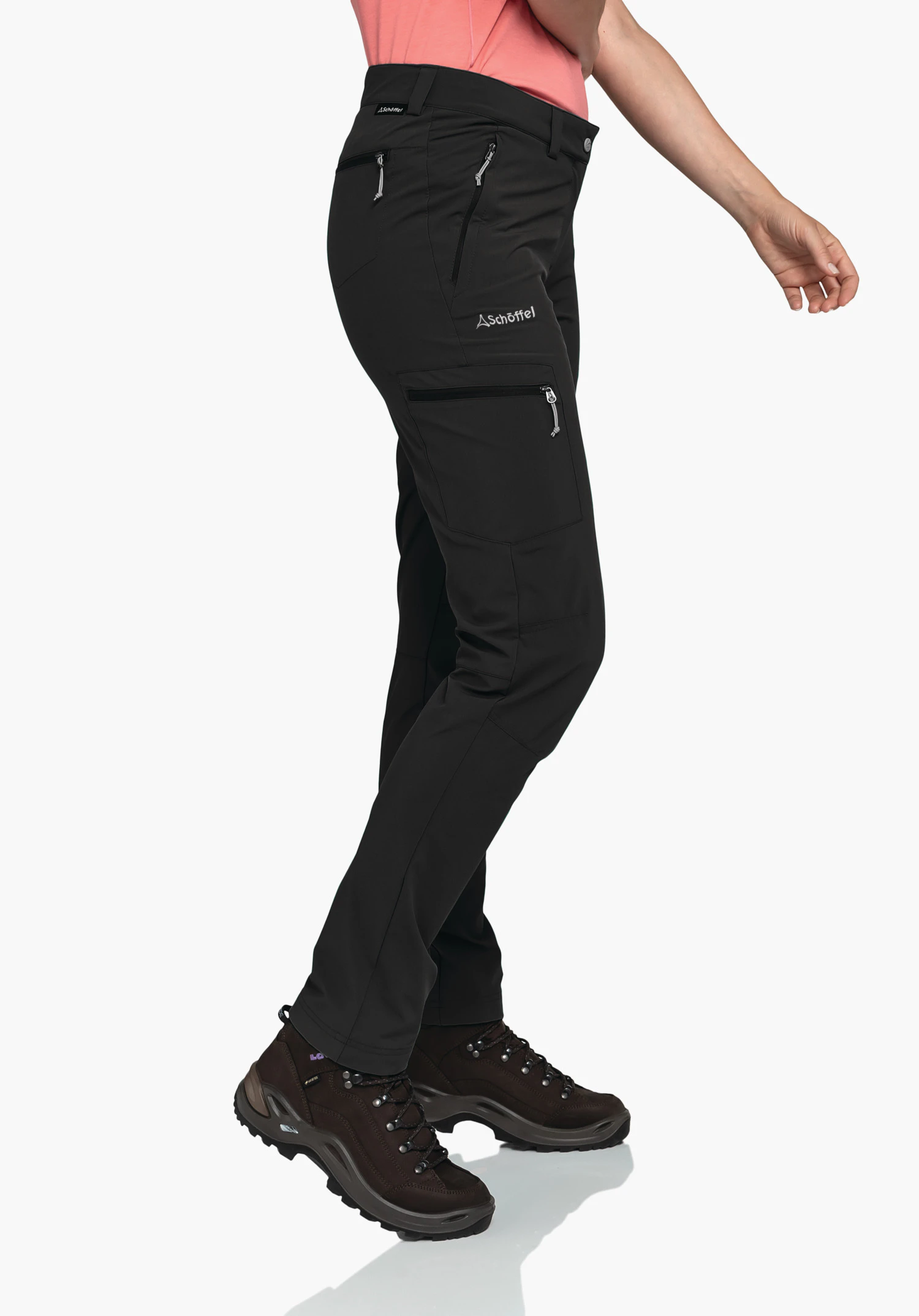 Pants Ascona in black, worn by a model standing sideways to showcase the zip pockets and the Schöffel-Logo on the thigh, against a neutral background.