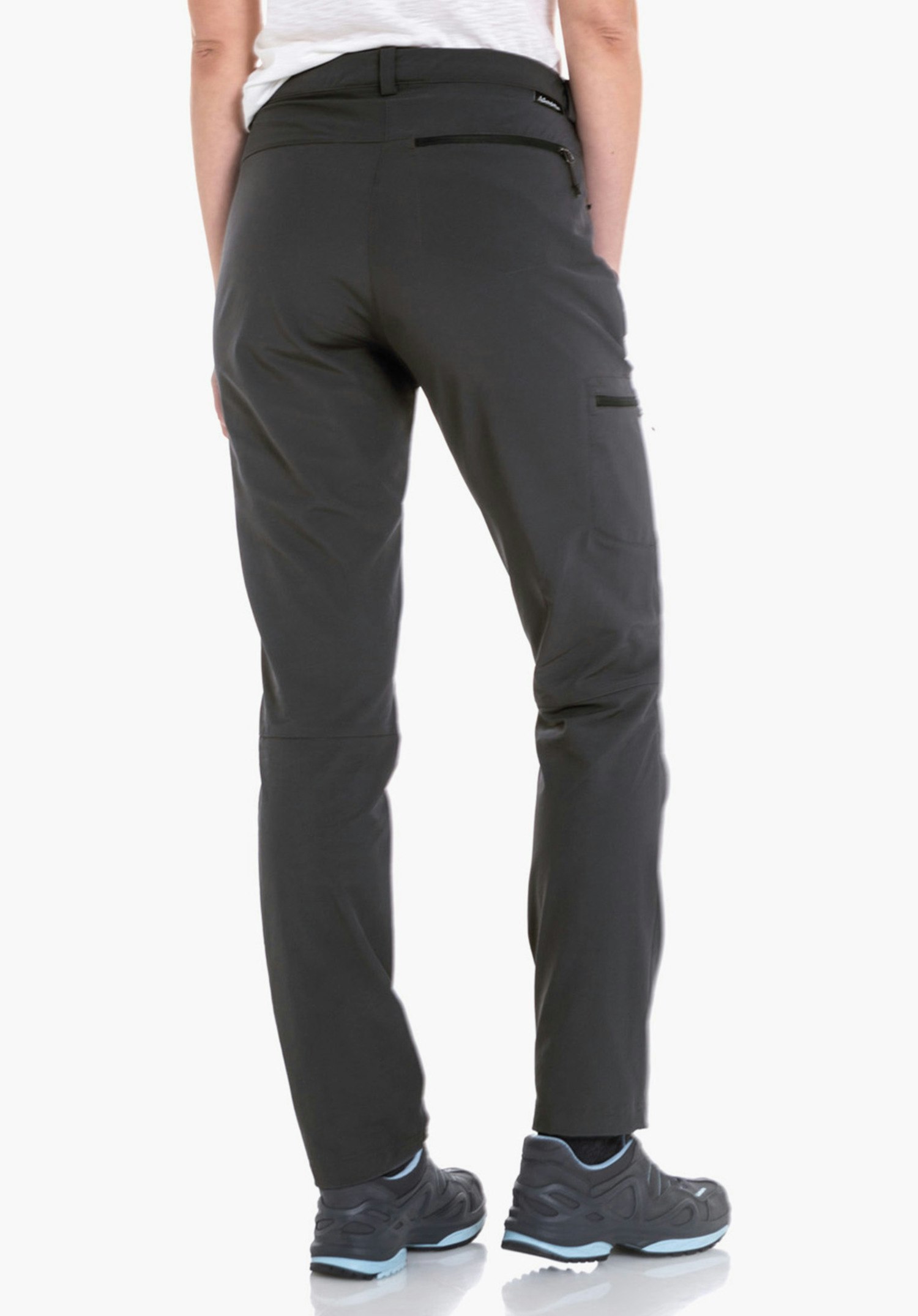 Pants Ascona schwarze Outdoorhose, von hinten getragen; Person steht, trägt hellgrün-rot kariertes Hemd, sichtbare Gesäßtasche und Wanderschuhe vor weißem Hintergrund.