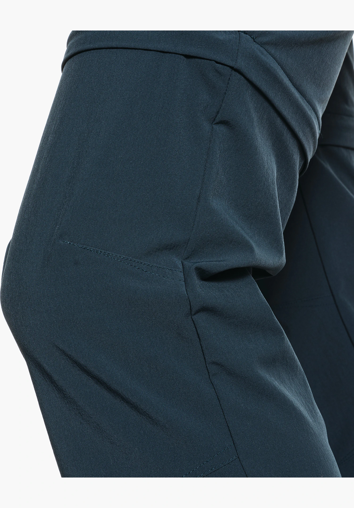 Pants Ascona Zip Off zeigt die vorgeformte Kniepartie und die Struktur des blauen Stoffes, Nahaufnahme vor weißem Hintergrund.