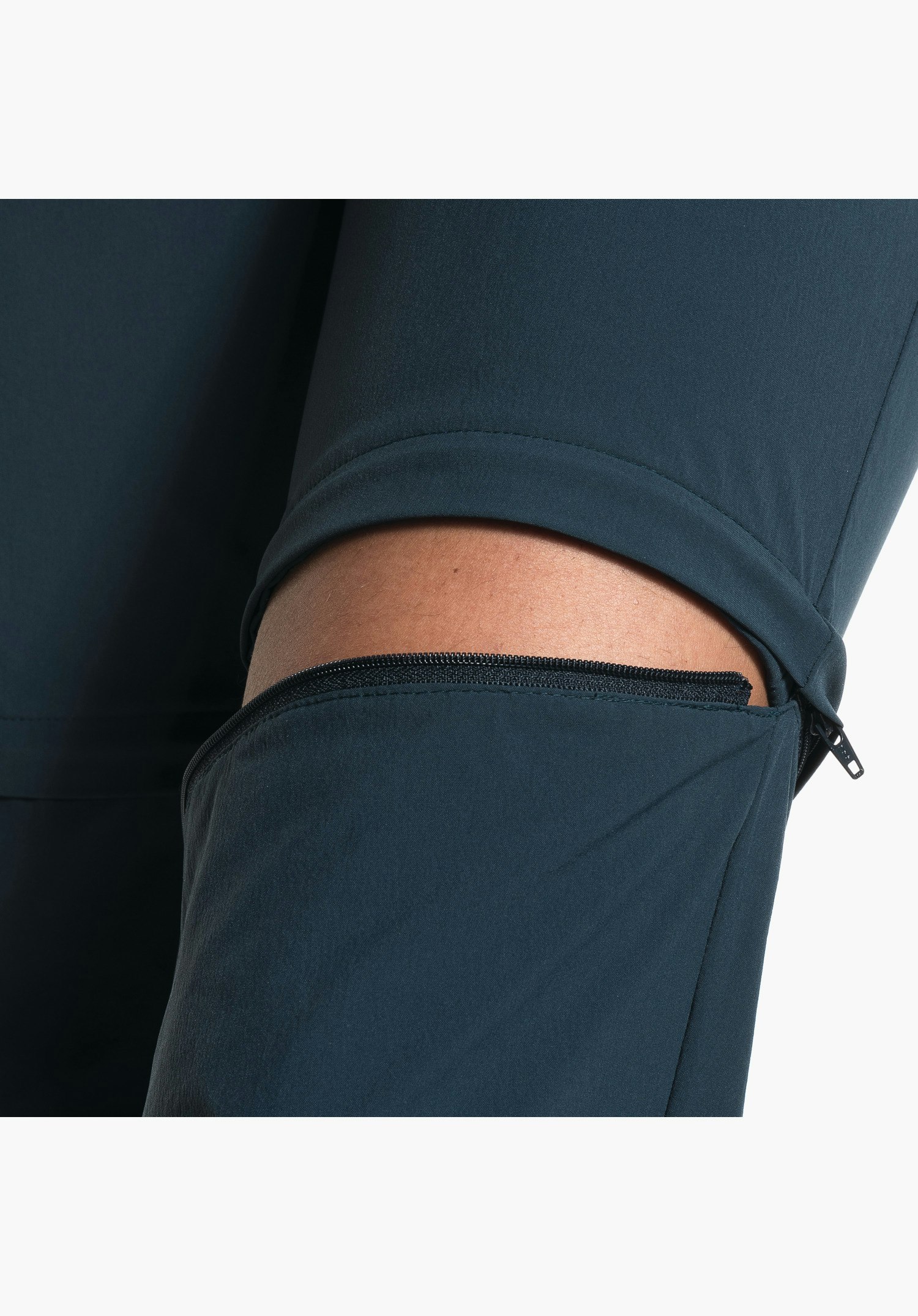 Pants Ascona Zip Off showing the zip of the detachable legs and the blue functional fabric. Close-up shot against a white background.