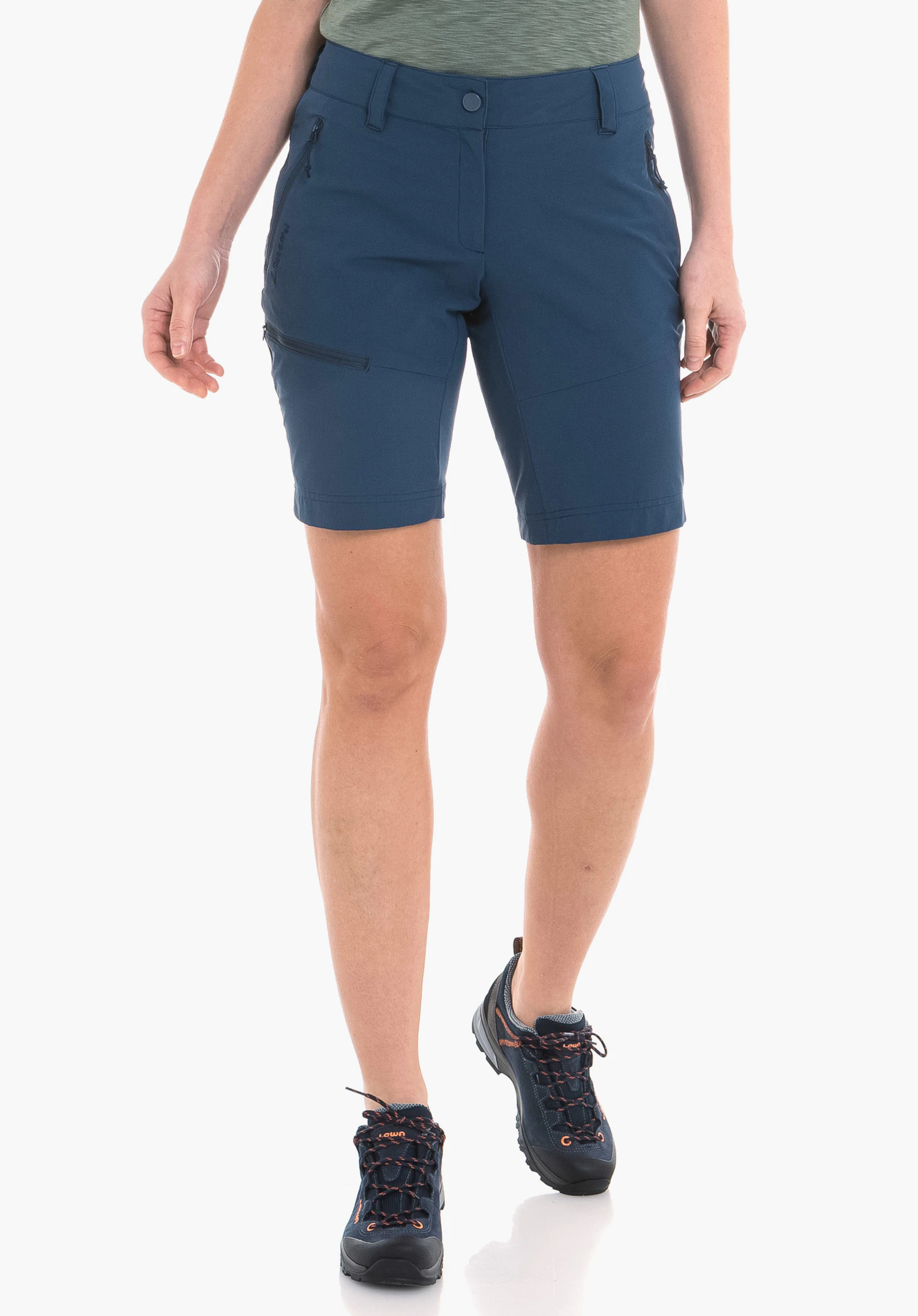 Shorts Toblach2 on a model in a front view. The short blue trousers feature practical zip pockets and a visible Schöffel logo on the right leg. The model stands against a neutral background.