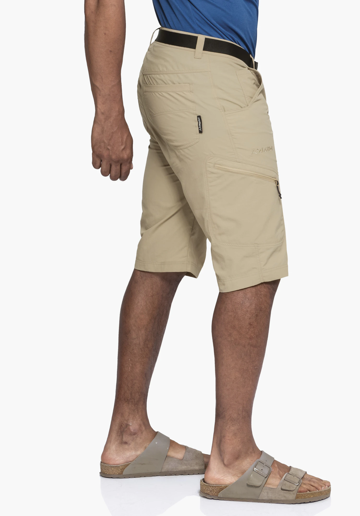 Shorts Silvaplana2 in beige: A model is captured from a side profile against a neutral background. The subtle Schöffel logo is clearly visible on the side of the leg and on the label just below the waistband.