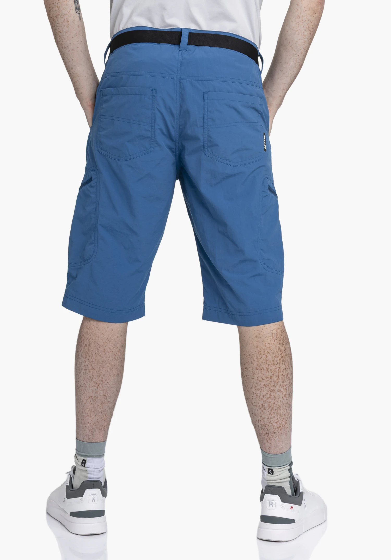 Shorts Silvaplana2 in a rear view on a model, showing the design in blue with an integrated belt and visible Schöffel-Logo against a neutral background.