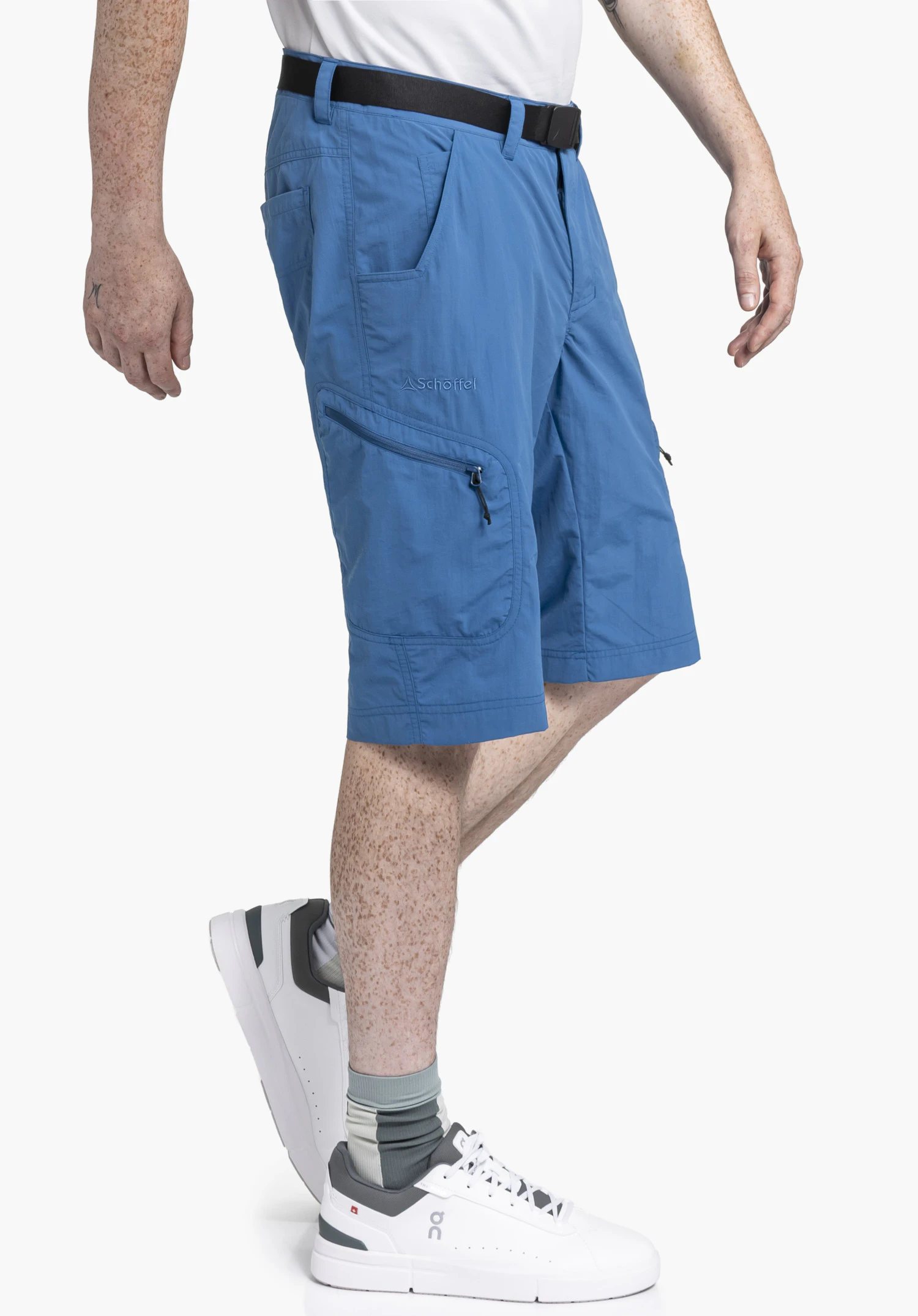 Shorts Silvaplana2 in blue, shown on a model in a side-stepping pose against a neutral background. The subtle Schöffel logo is clearly visible on the right leg.