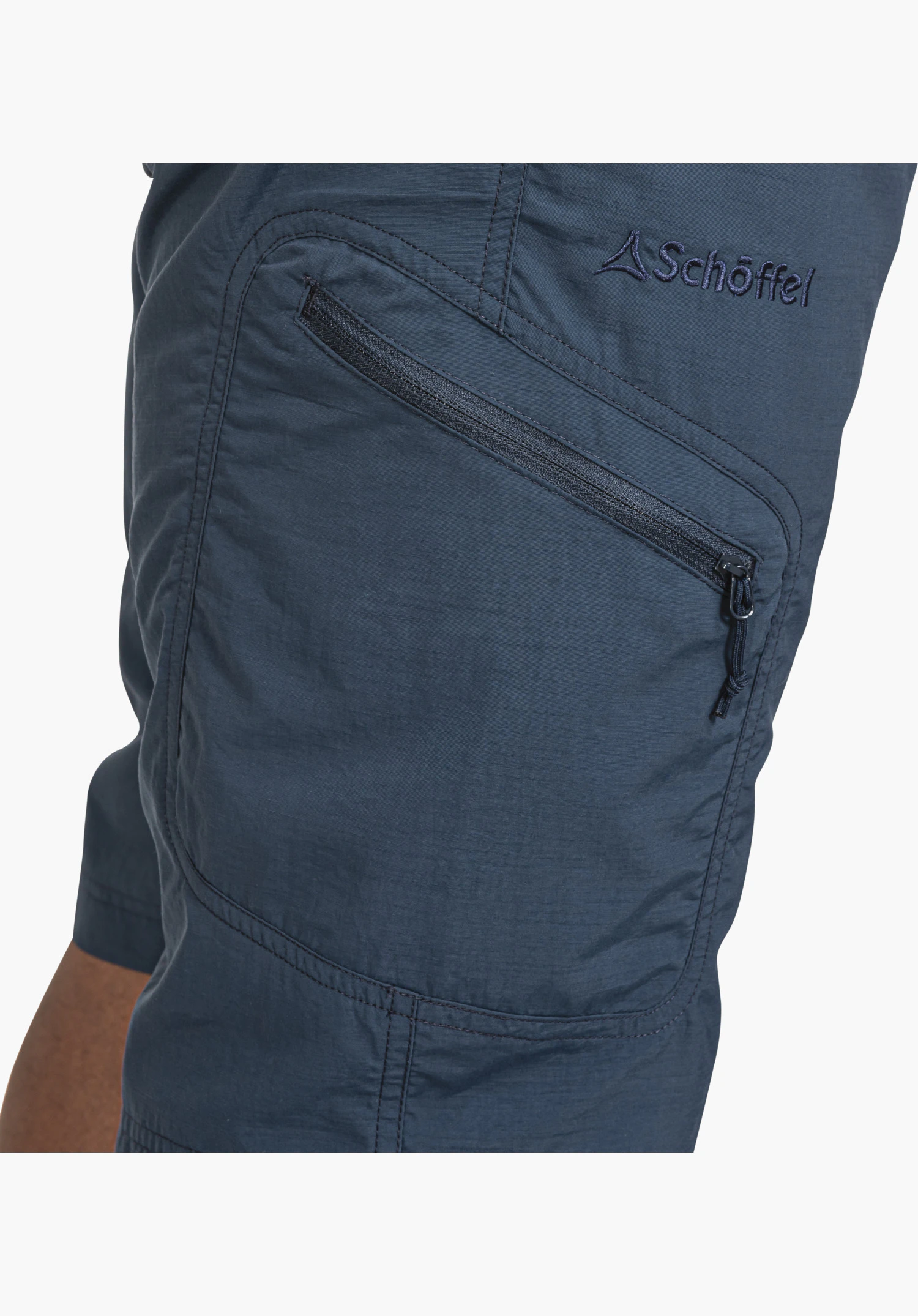 Shorts Silvaplana2 features the slanted side pocket with zip and the embroidered Schöffel logo on the blue fabric, close-up against a white/neutral background.