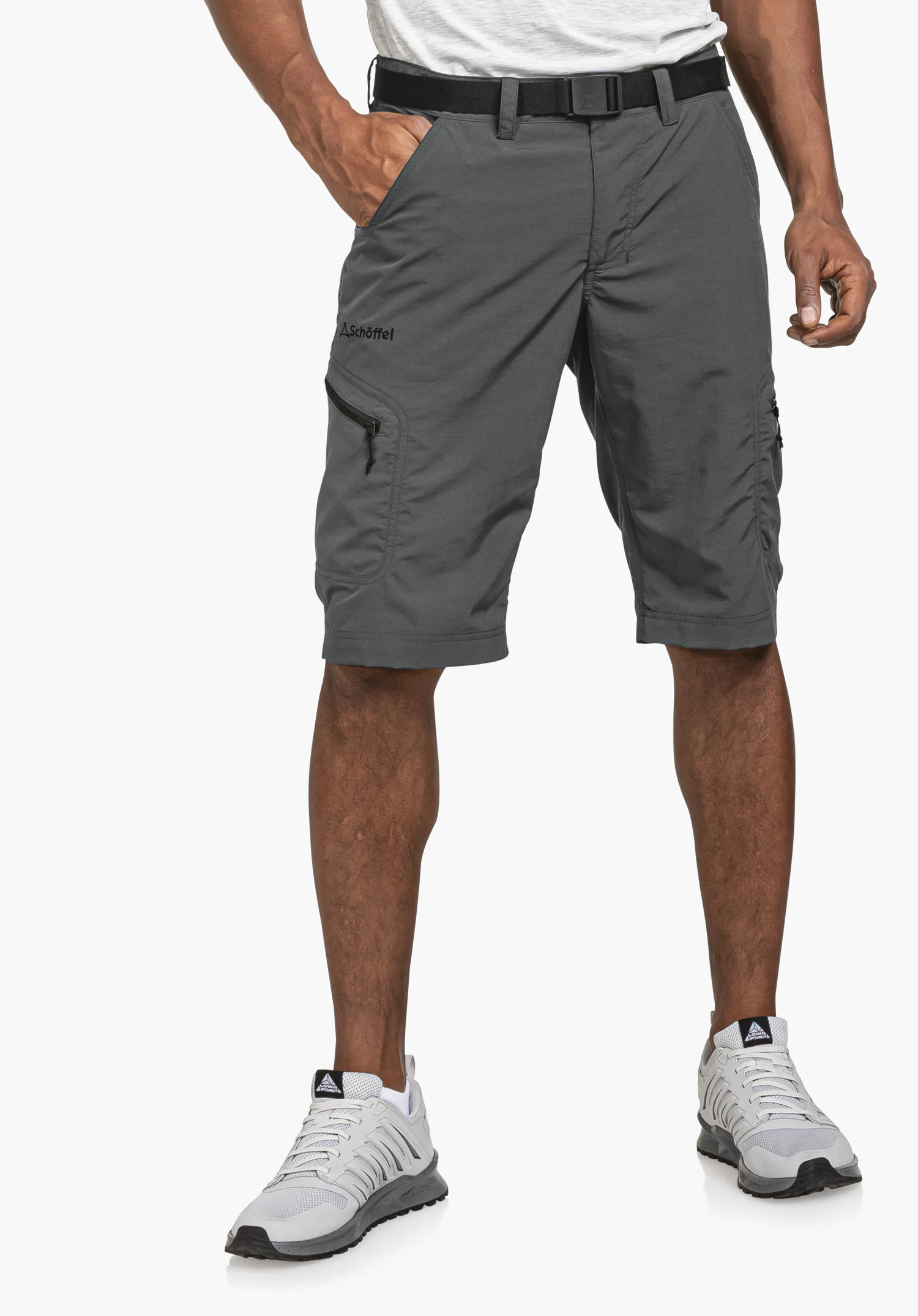 Shorts Silvaplana2 worn by a model standing facing forward with his right hand in the pocket. The grey shorts feature the visible Schöffel logo on the right leg and are presented against a neutral background.