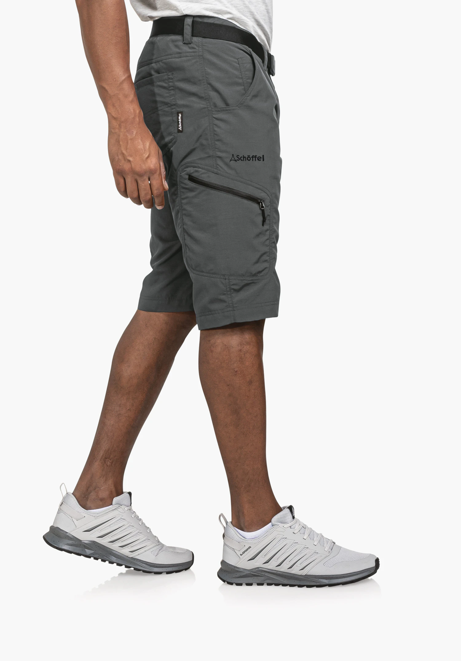 Shorts Silvaplana2 in grey, captured in a side profile view on a model against a neutral background. The shorts showcase a functional design, with the prominent Schöffel logo on the thigh subtly highlighting the high-quality craftsmanship.