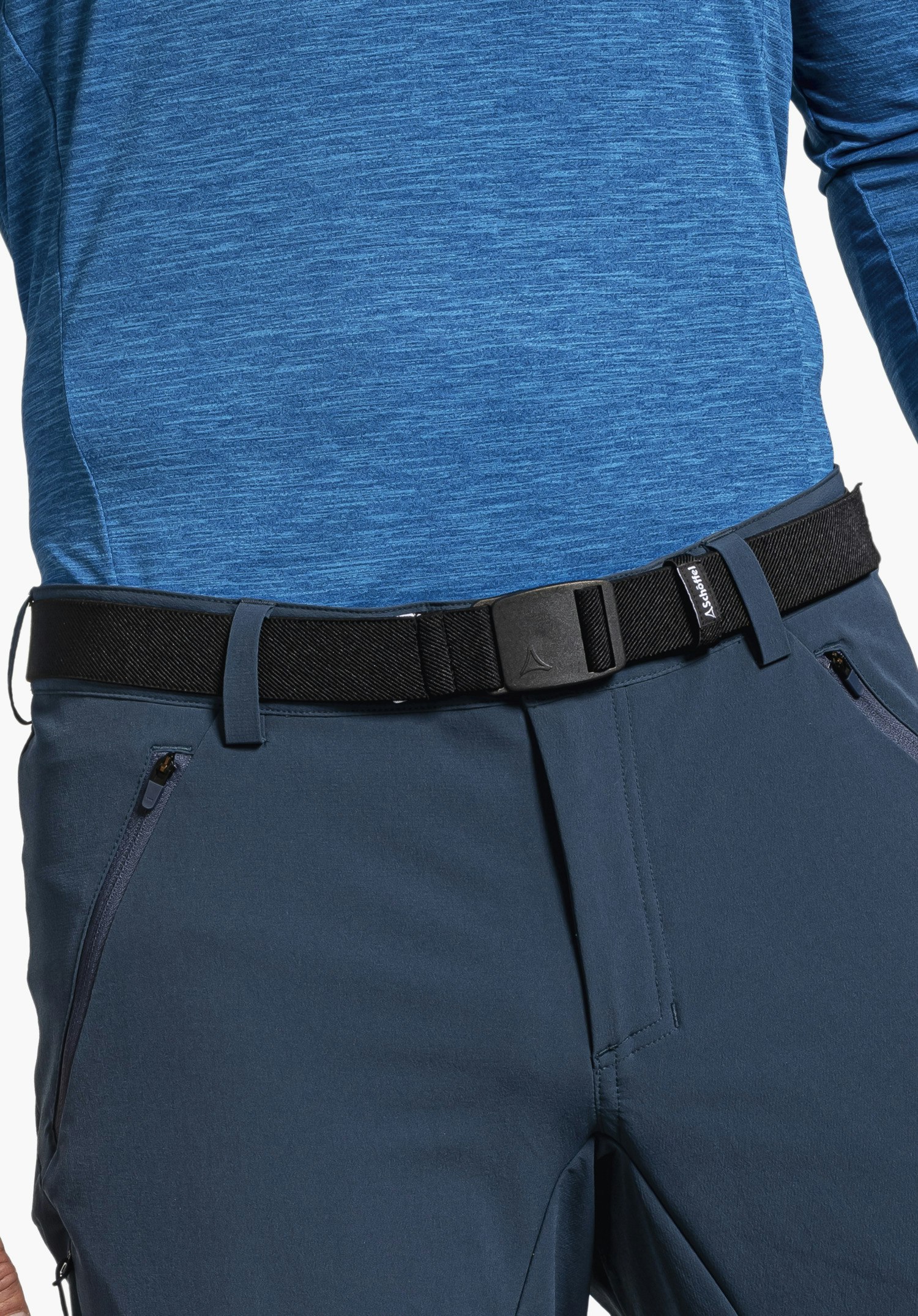 Belt Lenzerheide1 Black belt with Schöffel logo fastened around the waist, worn over dark blue trousers and a light blue long-sleeve shirt. Text: “Schöffel”.