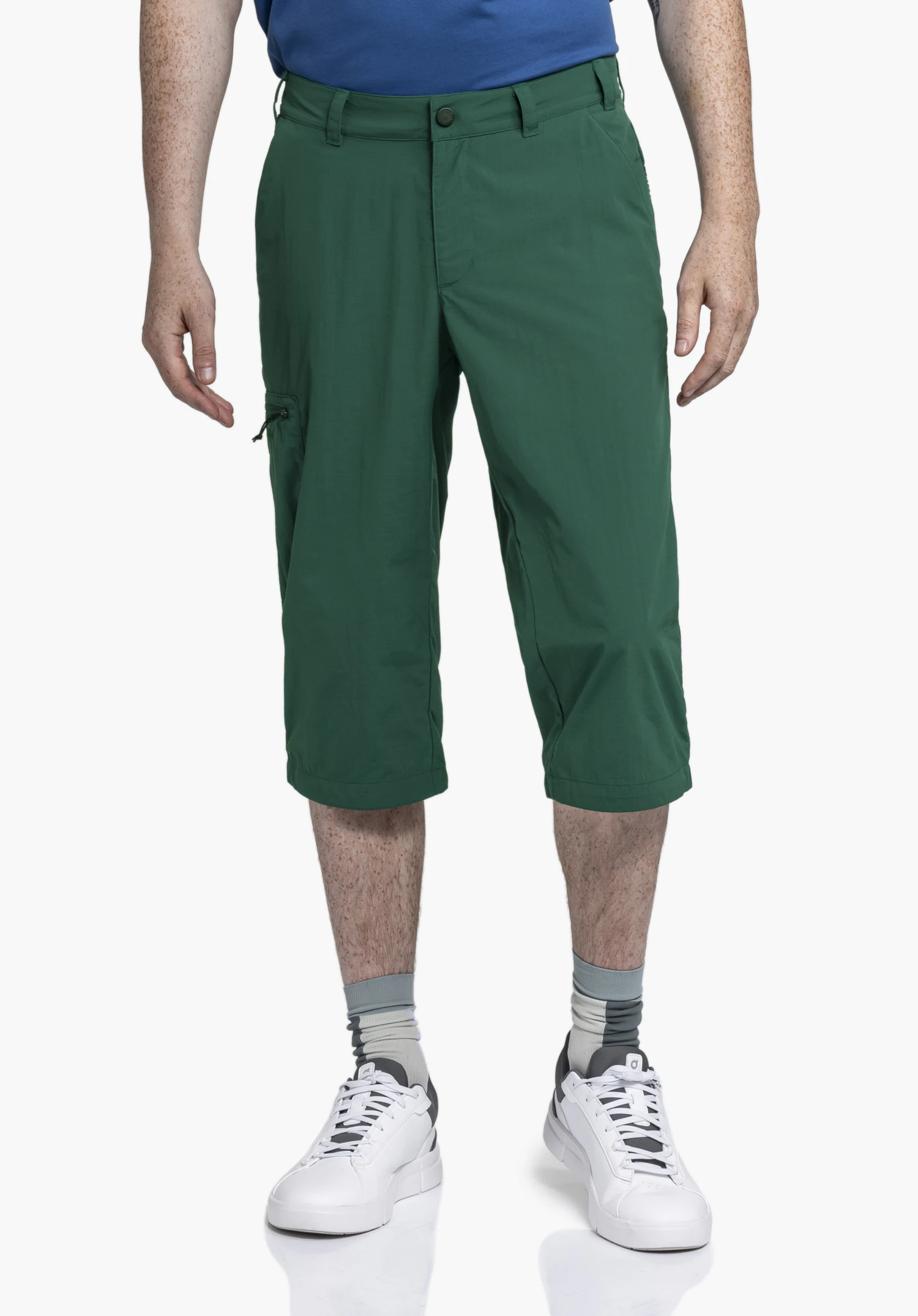 Pants Springdale1 on a model standing front-on, wearing the green 3/4-length trousers. Belt loops and a side zip pocket are visible, presented against a neutral background.