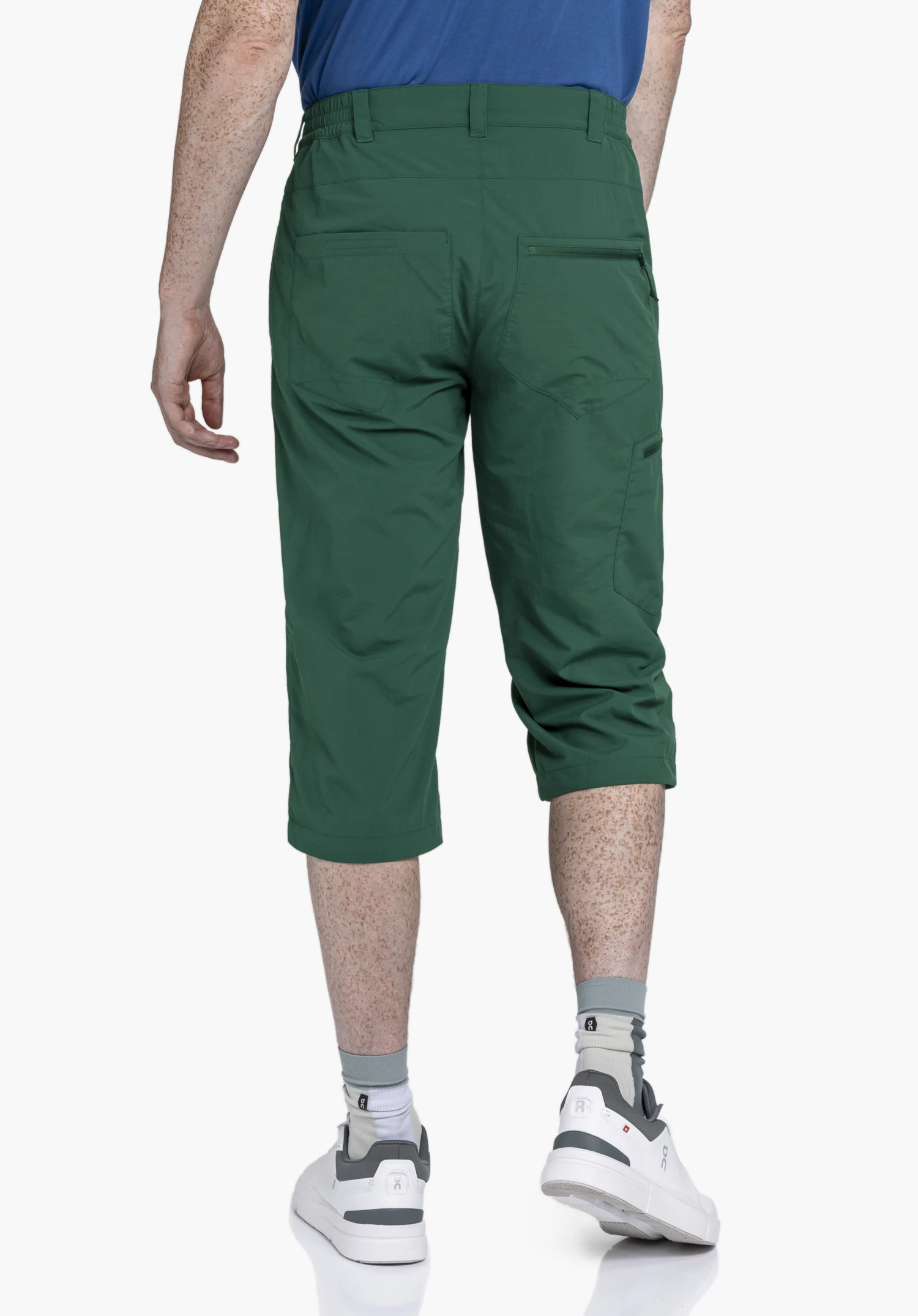 Pants Springdale1 in green in a rear view with the Schöffel logo against a neutral background.