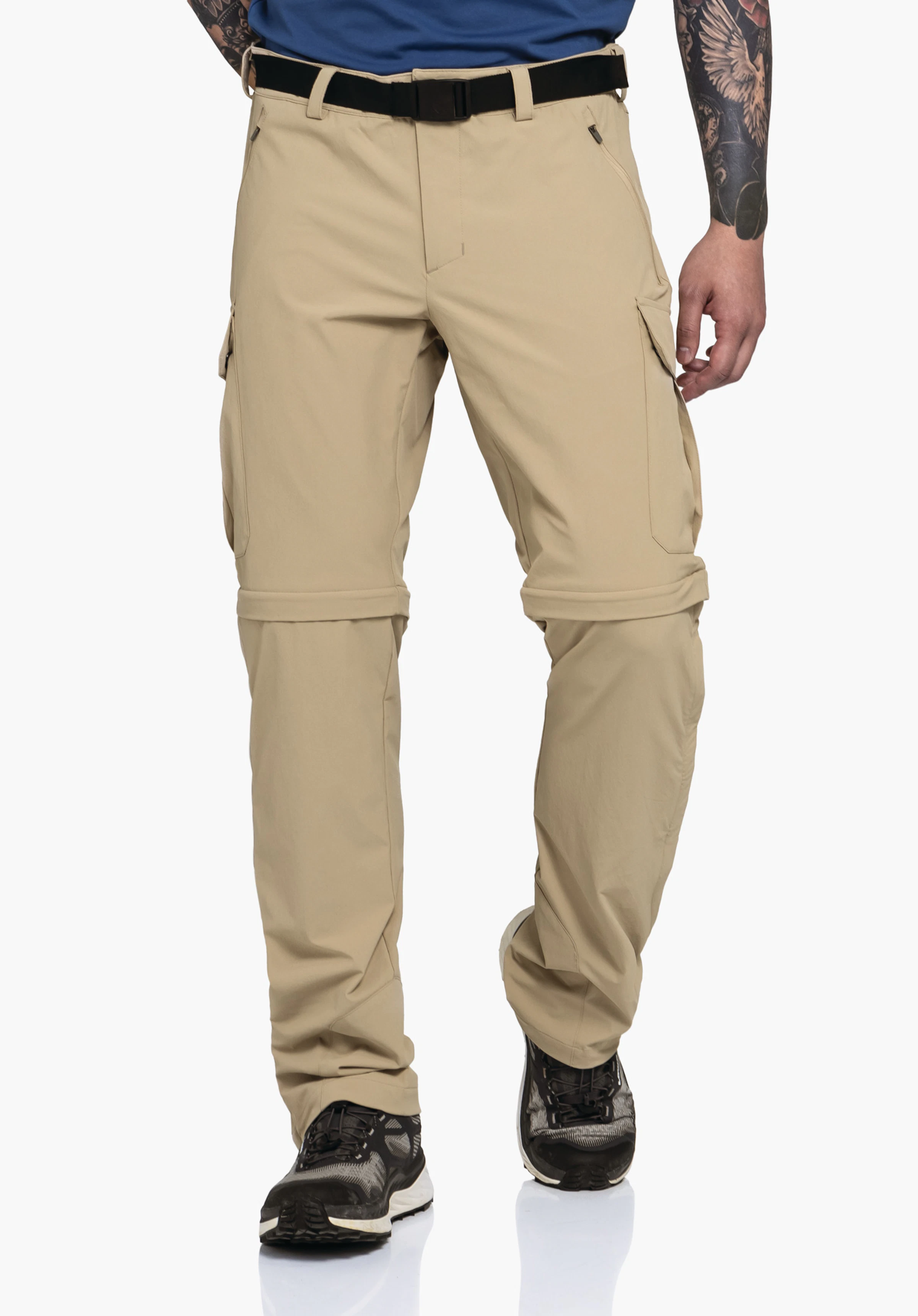 Pants Kyoto3 in Beige: Ein Model präsentiert die Hose in einer dynamischen Frontalansicht vor einem neutralen Hintergrund. Das funktionale Design und die präzise Passform kommen optimal zur Geltung.
