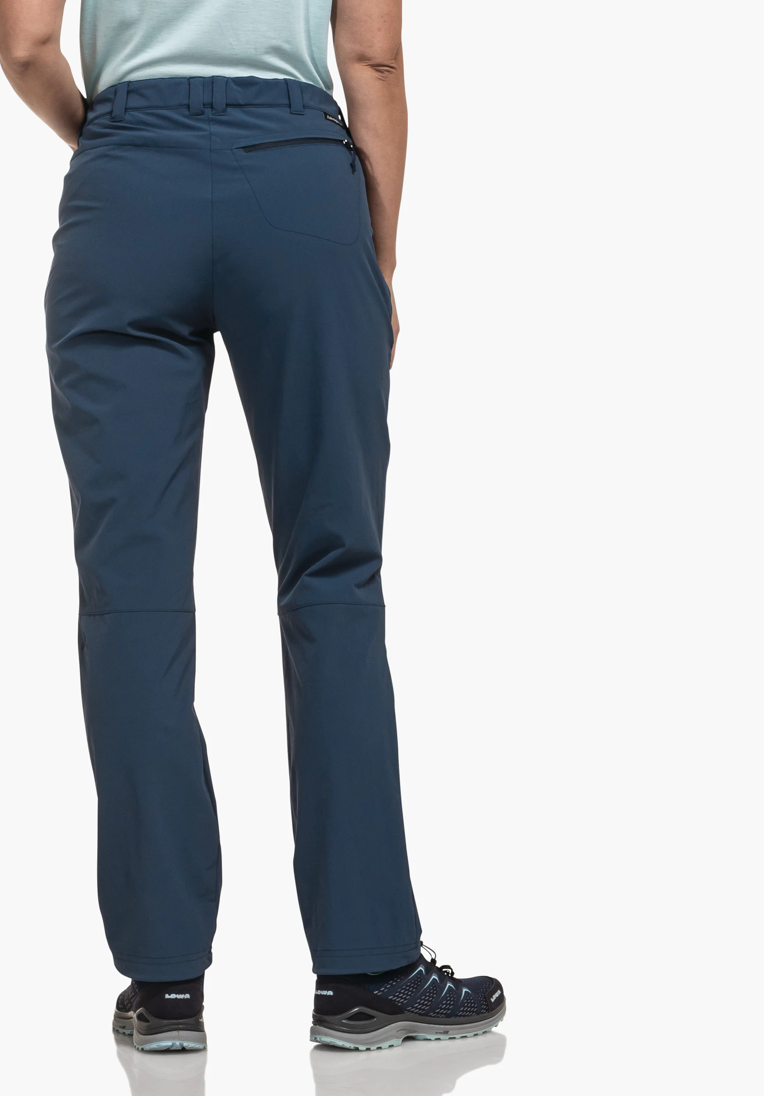 Pants Engadin1 dark blue trousers worn by a standing person from the back; hands at the sides, light blue top, dark blue trekking shoes; white studio background.