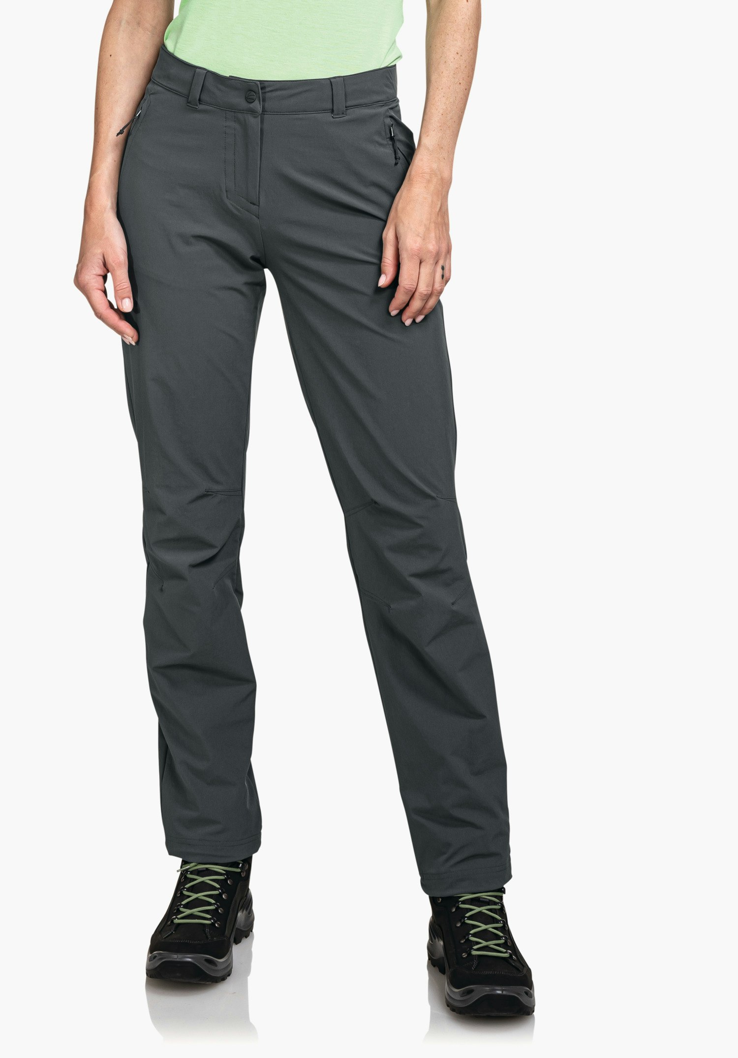 Pants Engadin1 dark grey outdoor trousers, worn by a standing person; hands at sides, light green top edge visible; black hiking shoes with green laces; neutral white background.