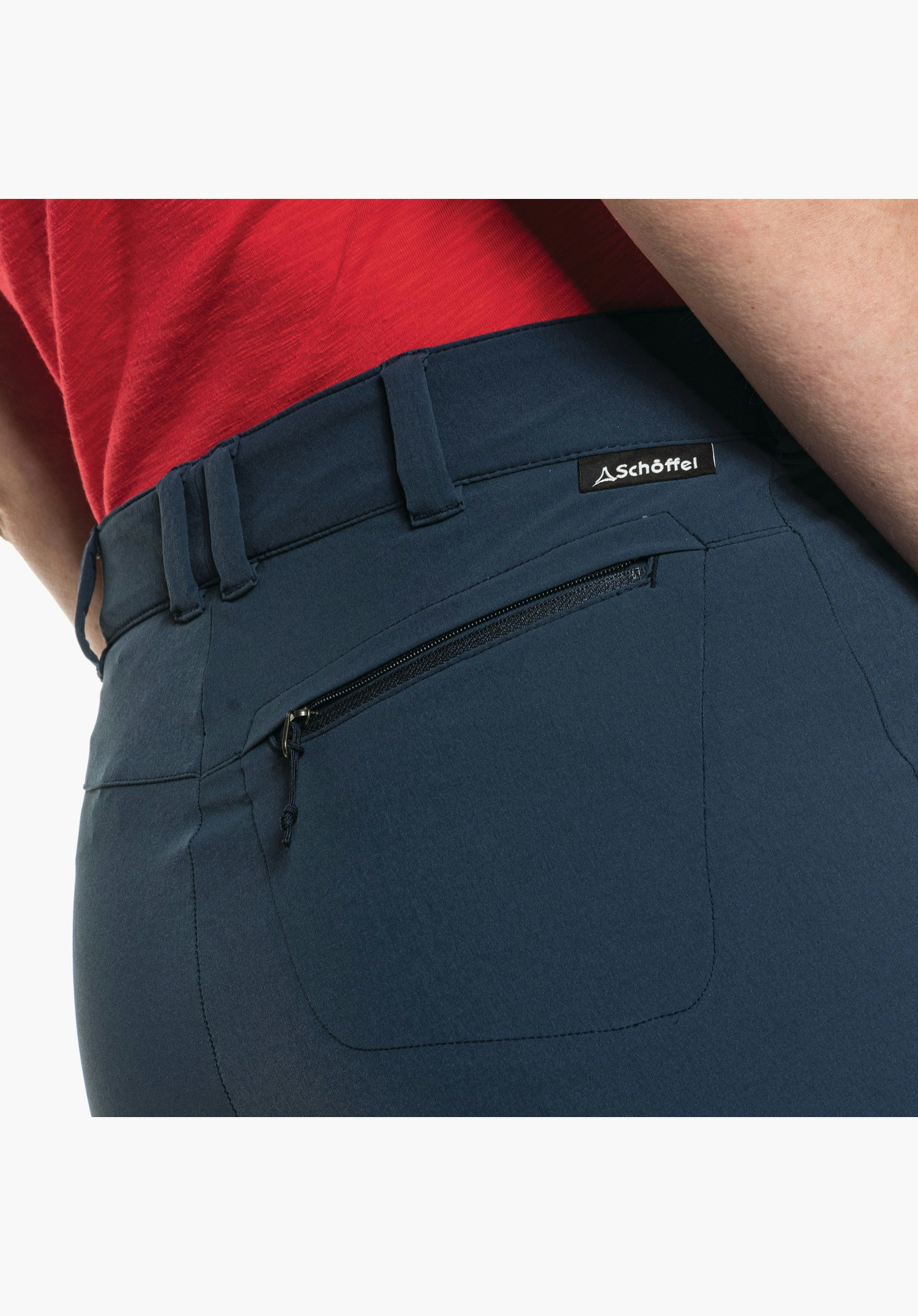 Pants Engadin1 Zip Off shows the rear view of the blue waistband with belt loops, a zipped pocket and the small Schöffel logo tag. Close-up against a white/neutral background.