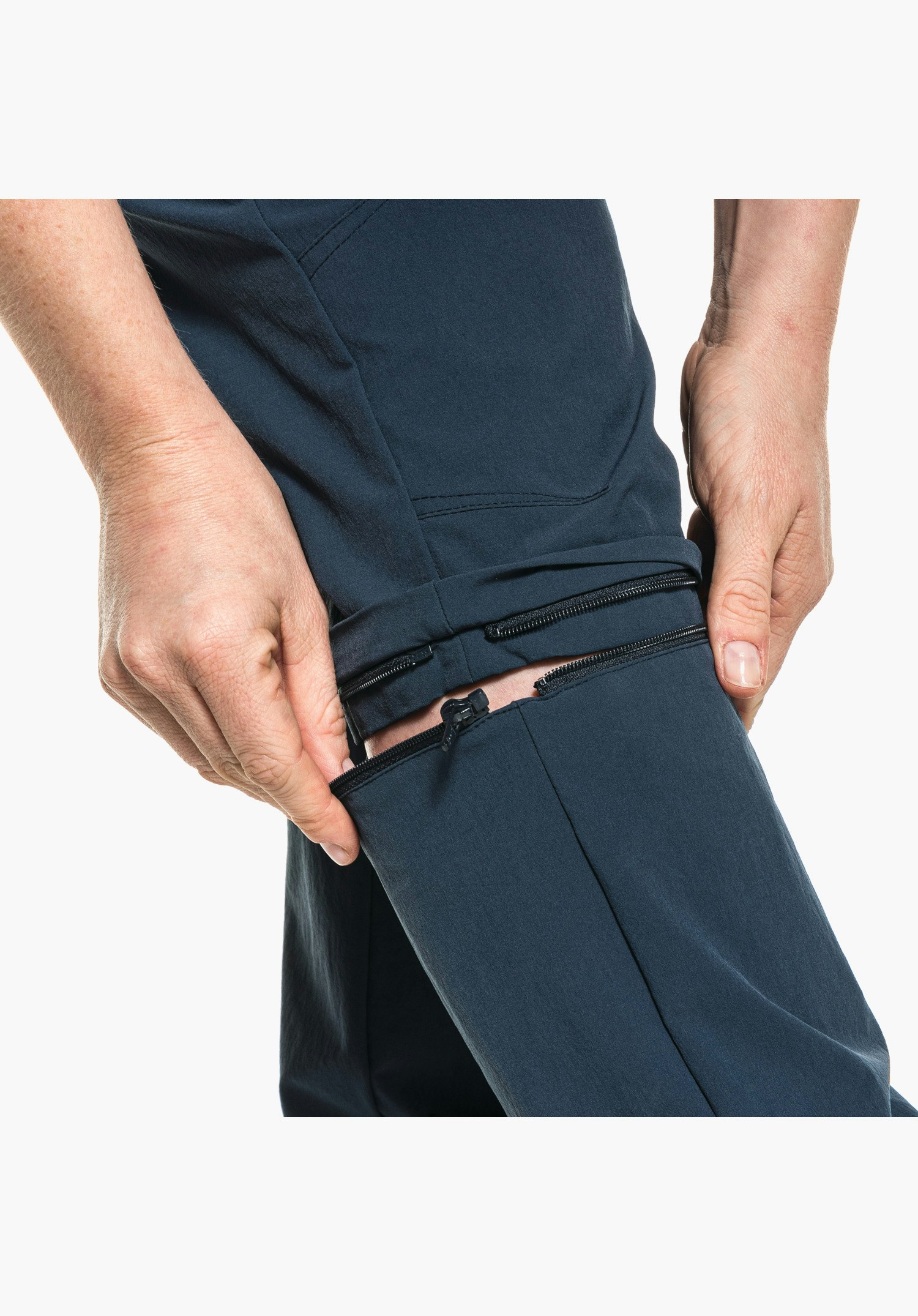Pants Engadin1 Zip Off shows the opened zip of the zip-off function on the blue trouser leg, close-up shot against a white/neutral background.