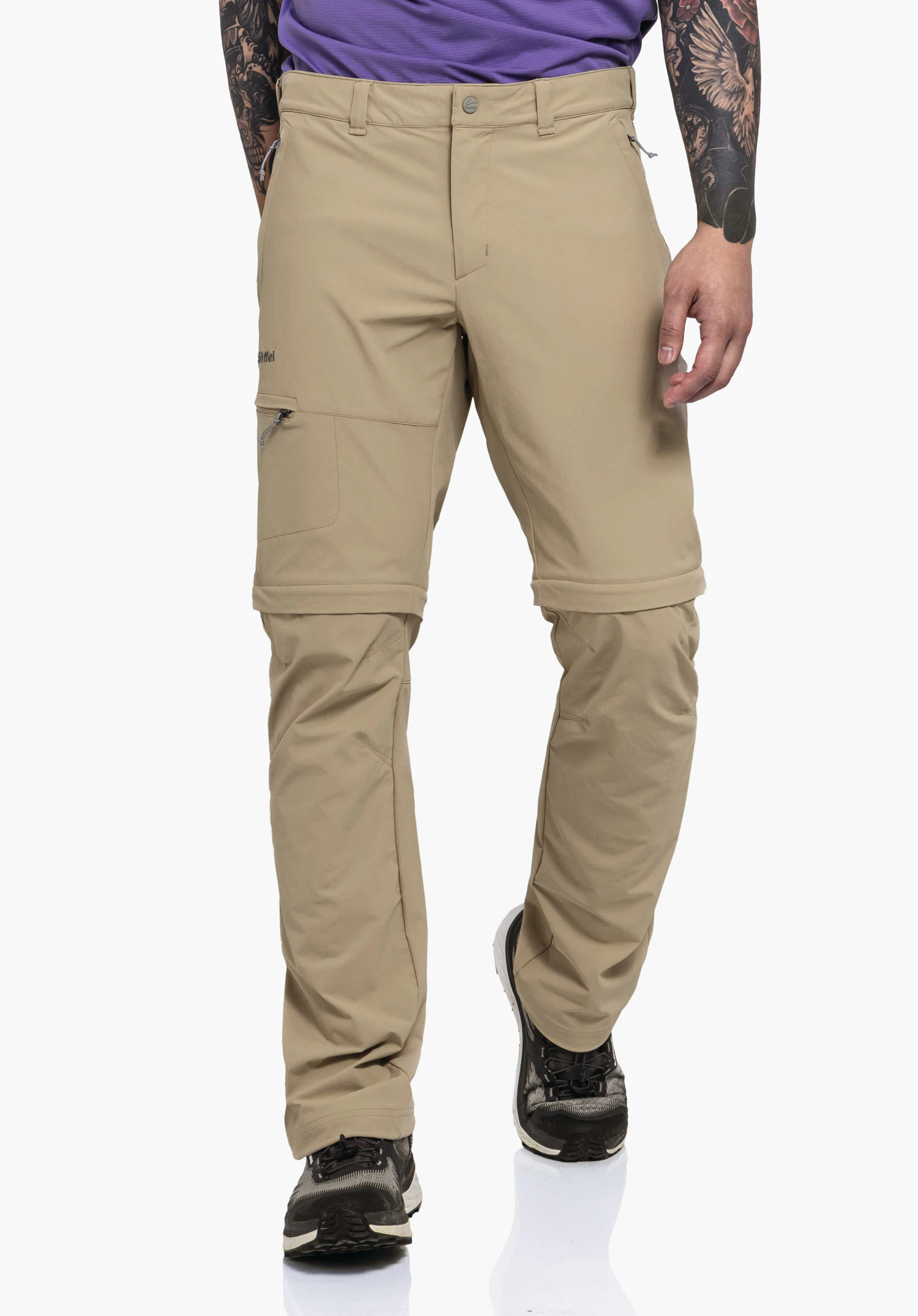 Pants Koper1 Zip Off worn by a model standing frontally. The beige trousers show the zip-off seams and the visible Schöffel logo on the right thigh, presented against a neutral background.