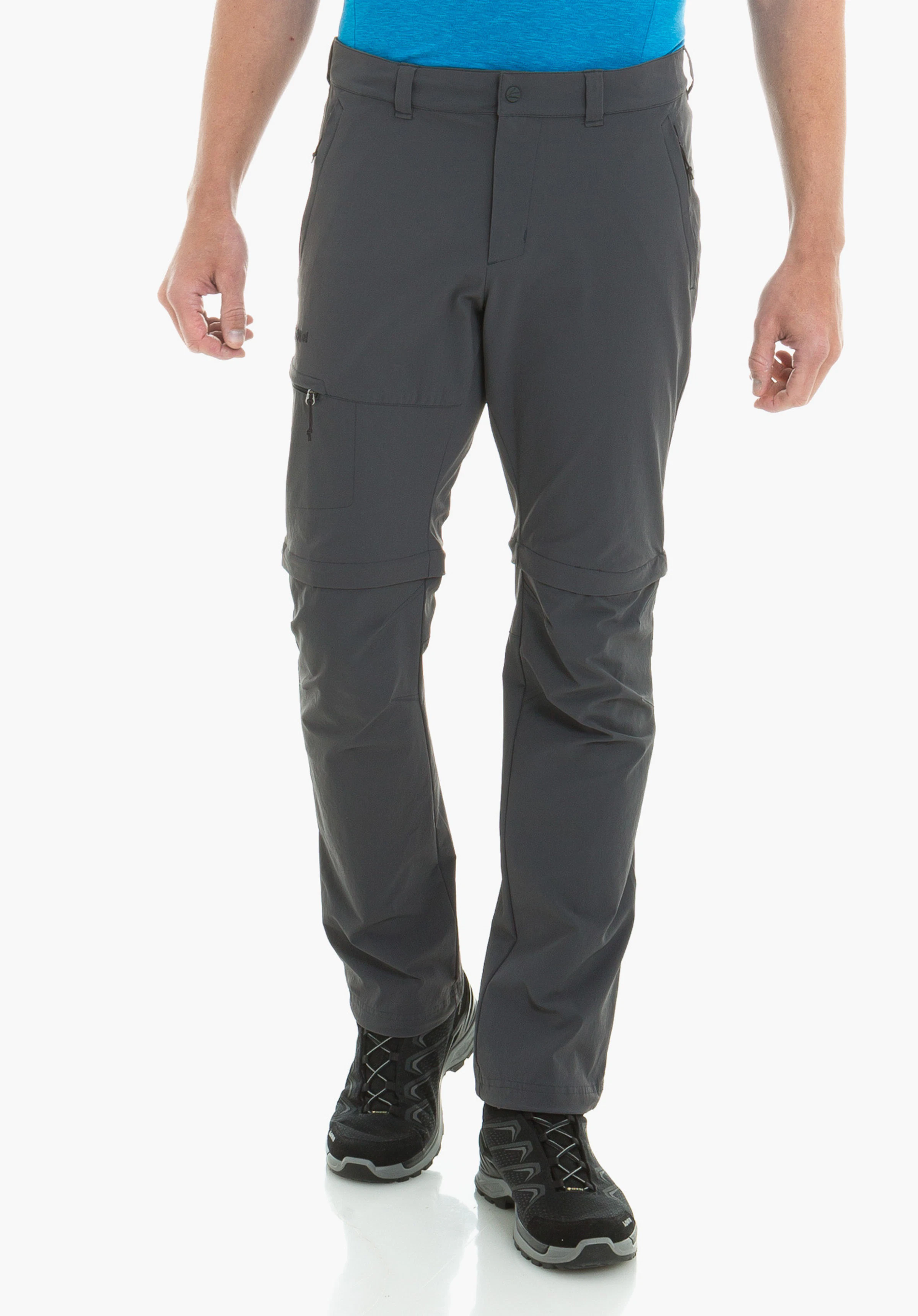 Pants Koper1 Zip Off dunkelblaue Zip-off-Hose, wird von einer stehenden Person getragen; hellblaues Shirt und schwarze Wanderschuhe sichtbar; neutraler Studiohintergrund.