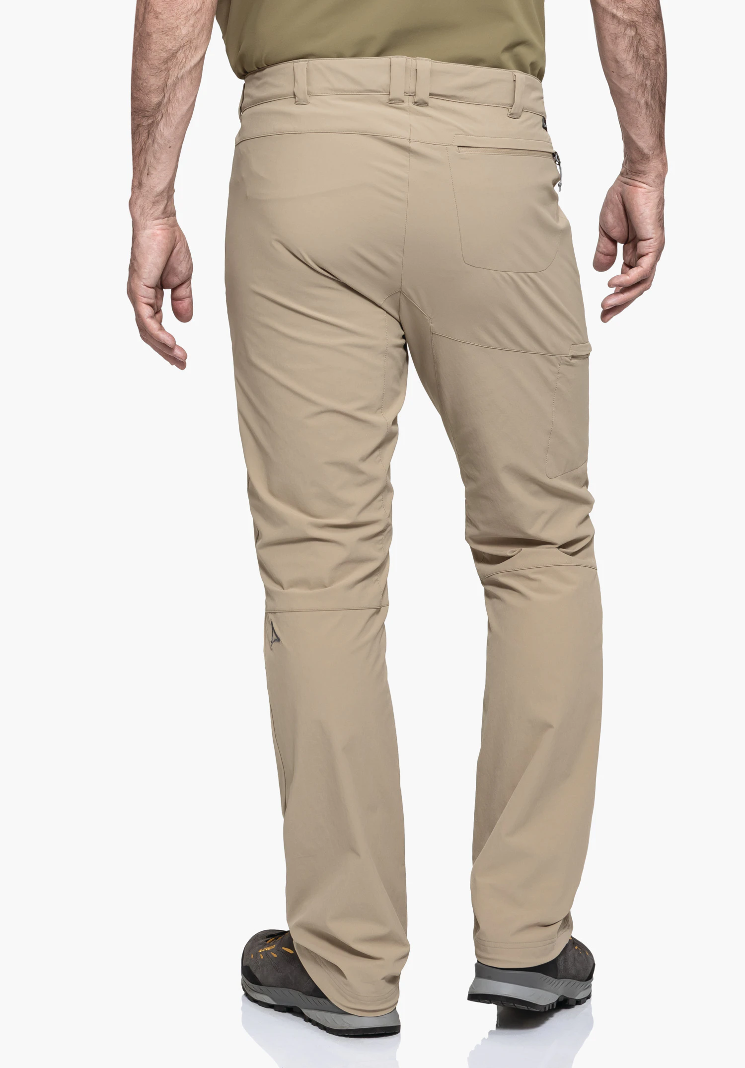 Pants Koper1 in the colour beige, worn by a model in a back view. The small Schöffel logo is visible on the back of the left leg, photographed against a neutral background.