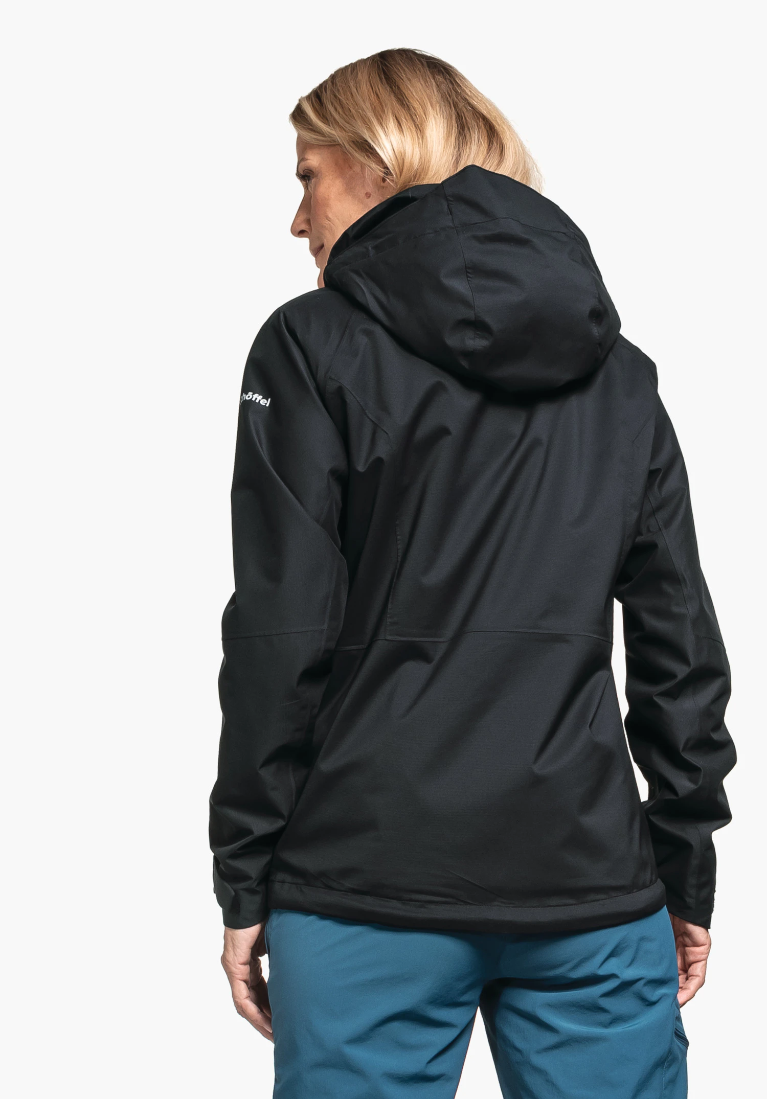 Jacket Easy XT L in black, worn by a model in a back view. The Schöffel-Logo is visible on the left sleeve. The model is standing against a neutral background.