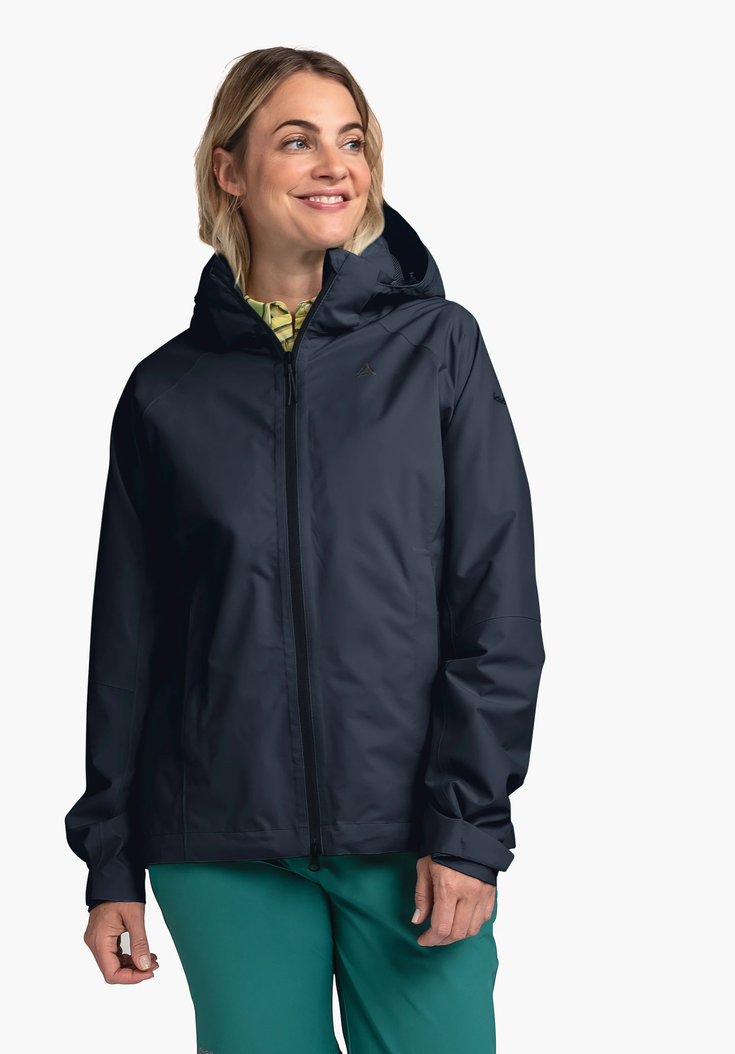 Jacket Easy XT L worn by a smiling model standing slightly to the side. The blue jacket features a hood, a front zip and a subtle Schöffel logo on the left chest, photographed against a neutral background.
