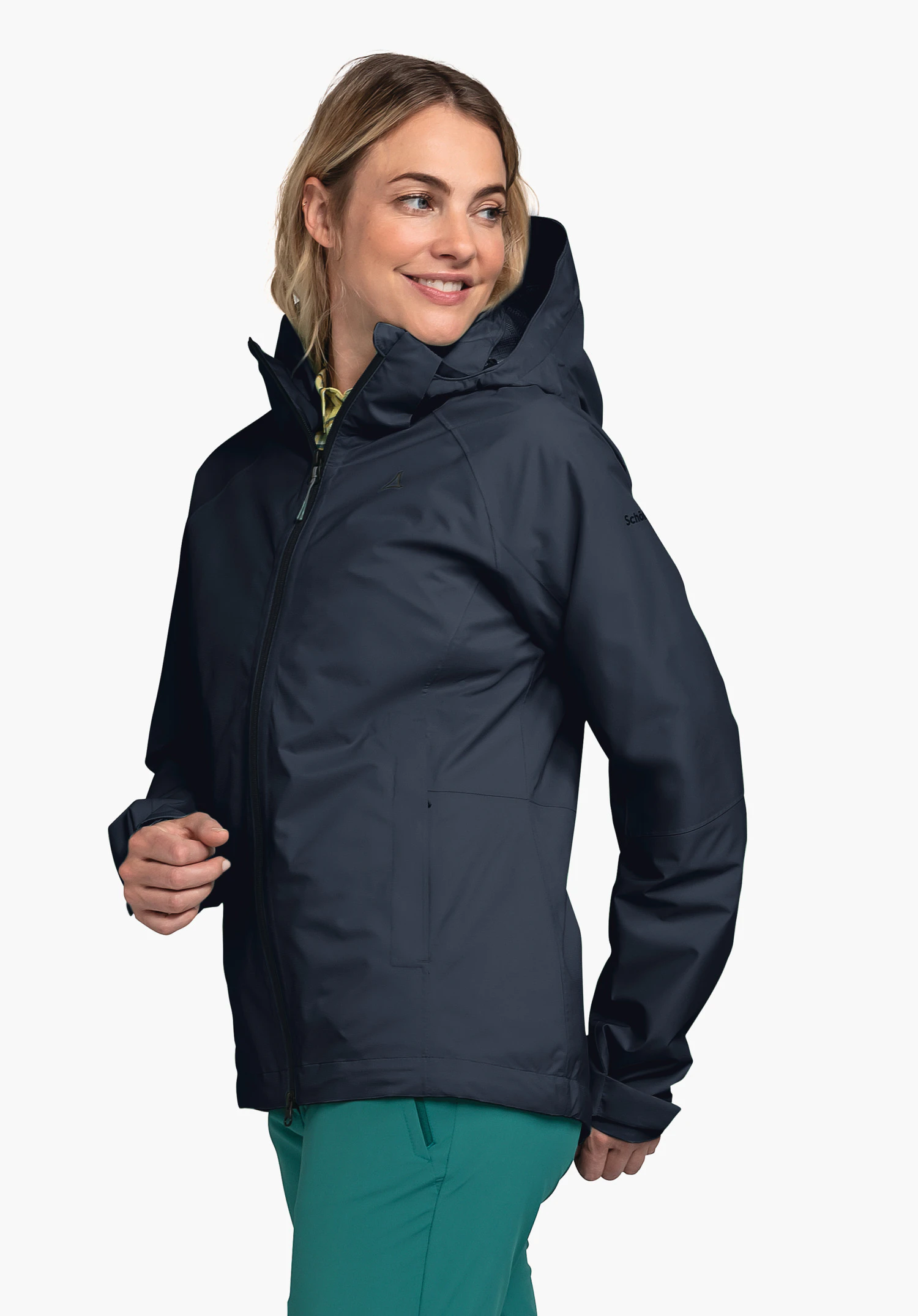 Jacket Easy XT L in blue, worn by a model standing sideways and looking to the side with a smile. The Schöffel logo is visible on the left sleeve, presented against a neutral background.