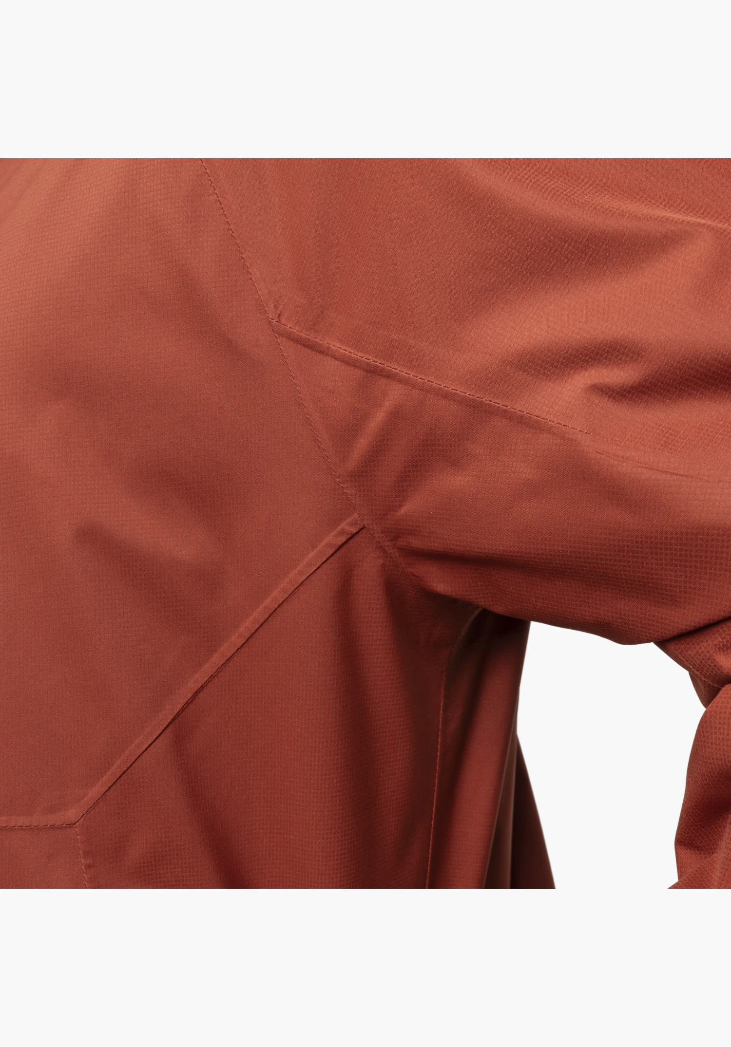 Jacket Easy XT M, fine ripstop structure of the red fabric and ergonomic panel cut in the underarm area, close-up against a white/neutral background.