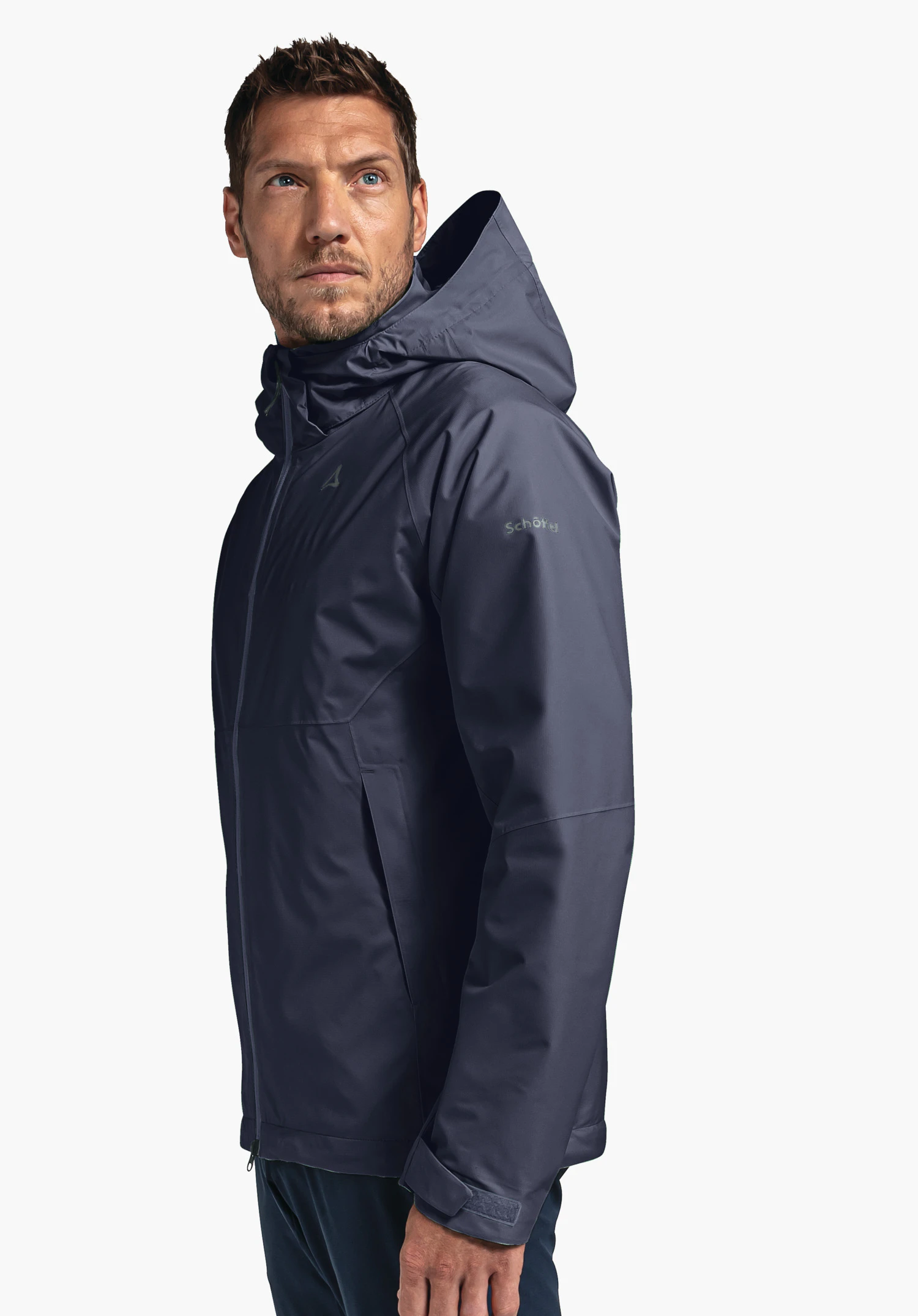 Jacket Easy XT M in blue on a model standing sideways with the Schöffel logo visible on the left sleeve, presented against a neutral background.
