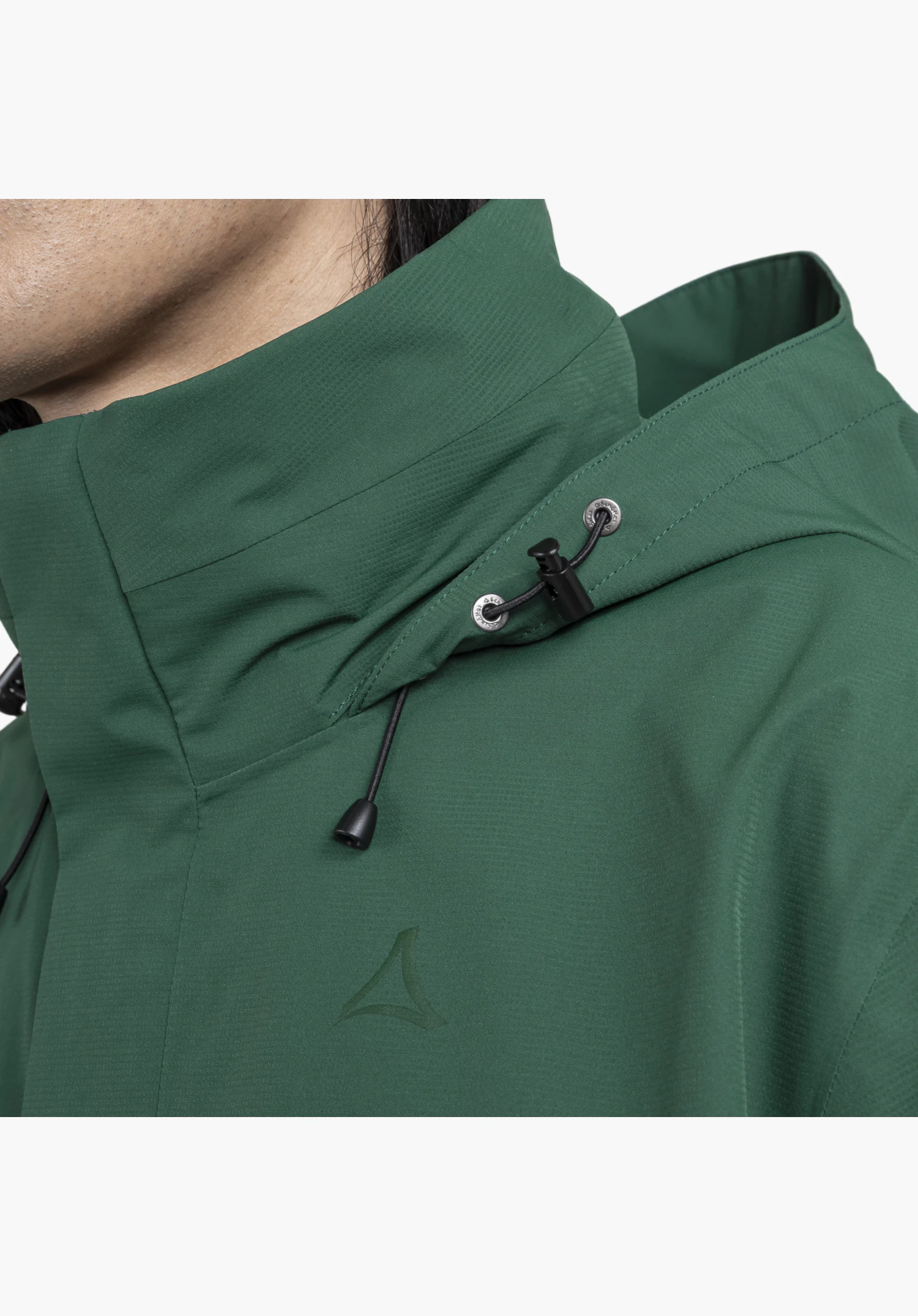 Jacket Gmund M showing the collar area in green fabric, the hood's adjustable cord system with a black toggle, and the colour-coordinated Schöffel-Logo on the chest as a close-up against a white/neutral background.