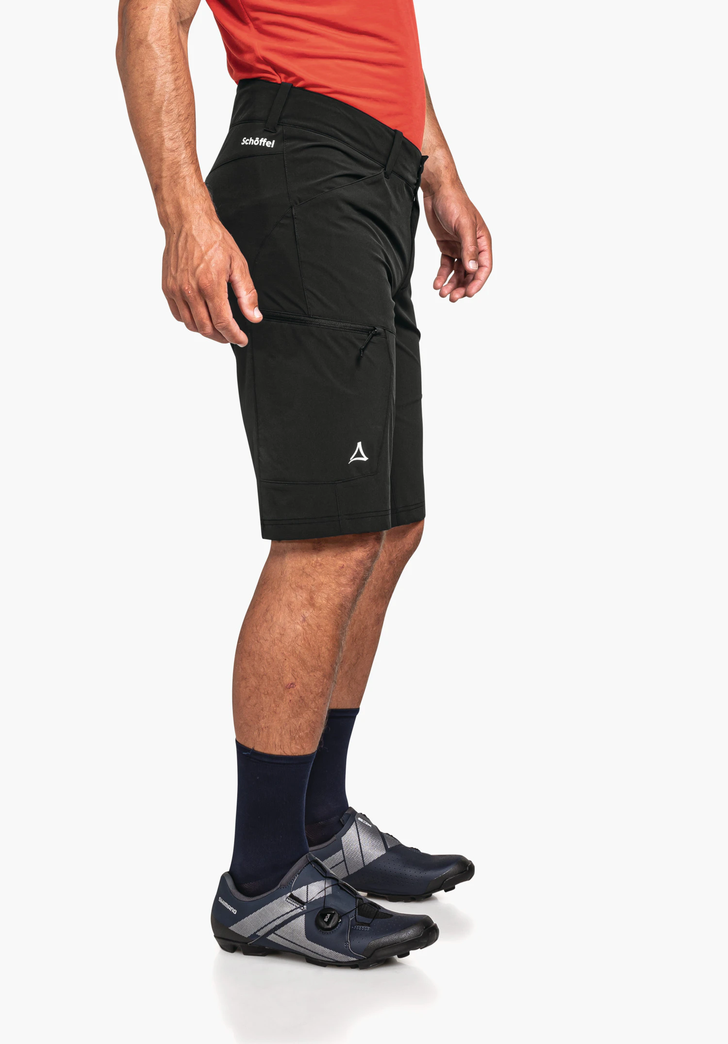 Shorts Danube M in zwart voor een neutrale achtergrond. Het model staat zijwaarts en toont de functionele pasvorm. Het reflecterende Schöffel-logo op de dij en het opschrift op de tailleband zijn duidelijk zichtbaar.