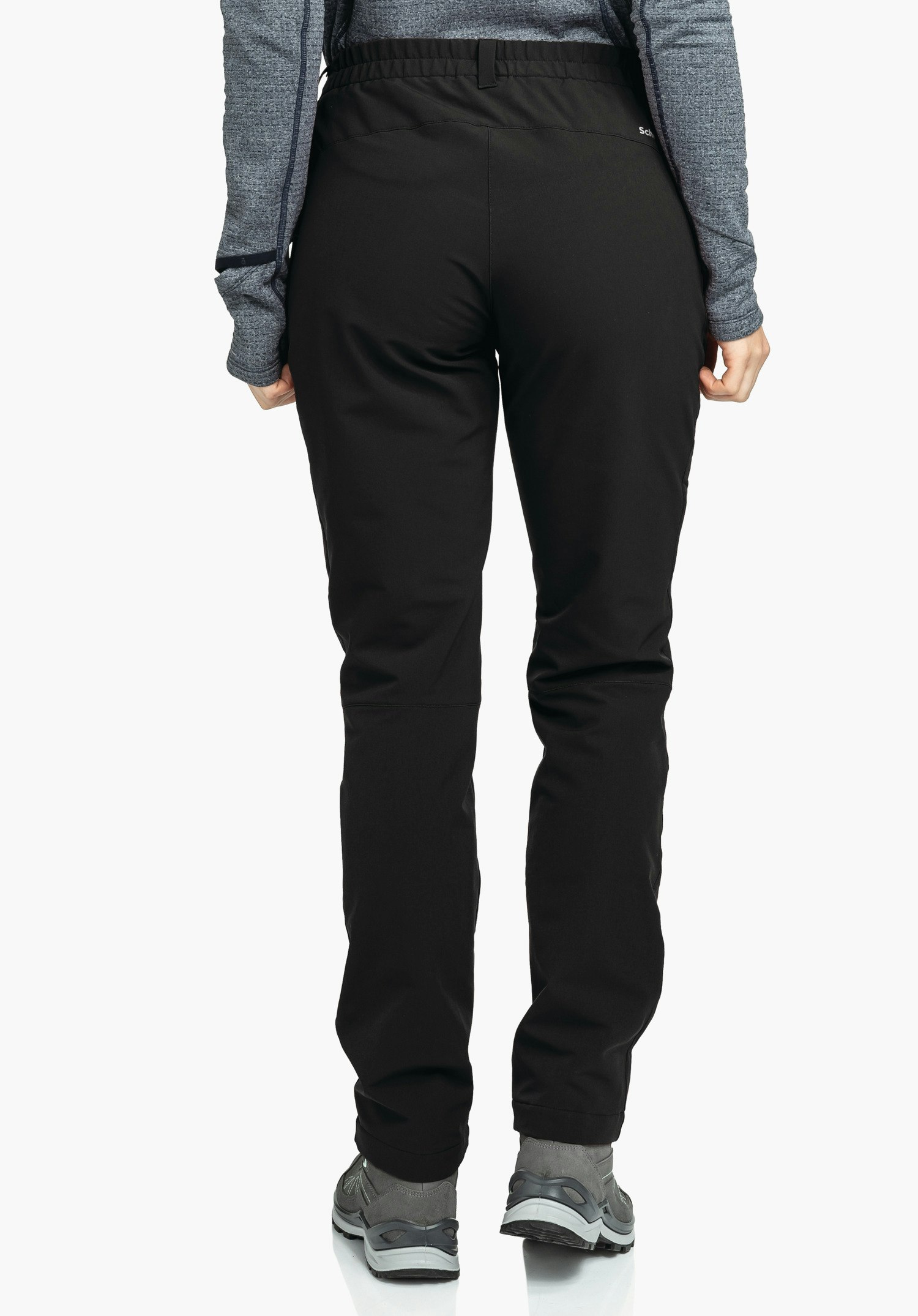 Pants Ascona Warm L black trousers worn by a standing person, slightly angled rear view; context: white background, dark blue long-sleeve top and grey hiking shoes.