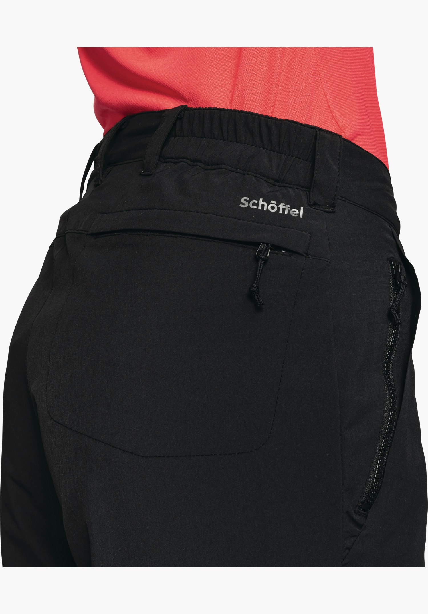 Pants Engadin1 Warm L shows the rear black waistband with belt loops, elasticated insert, the zipped pocket and the Schöffel logo in a close-up against a white/neutral background.
