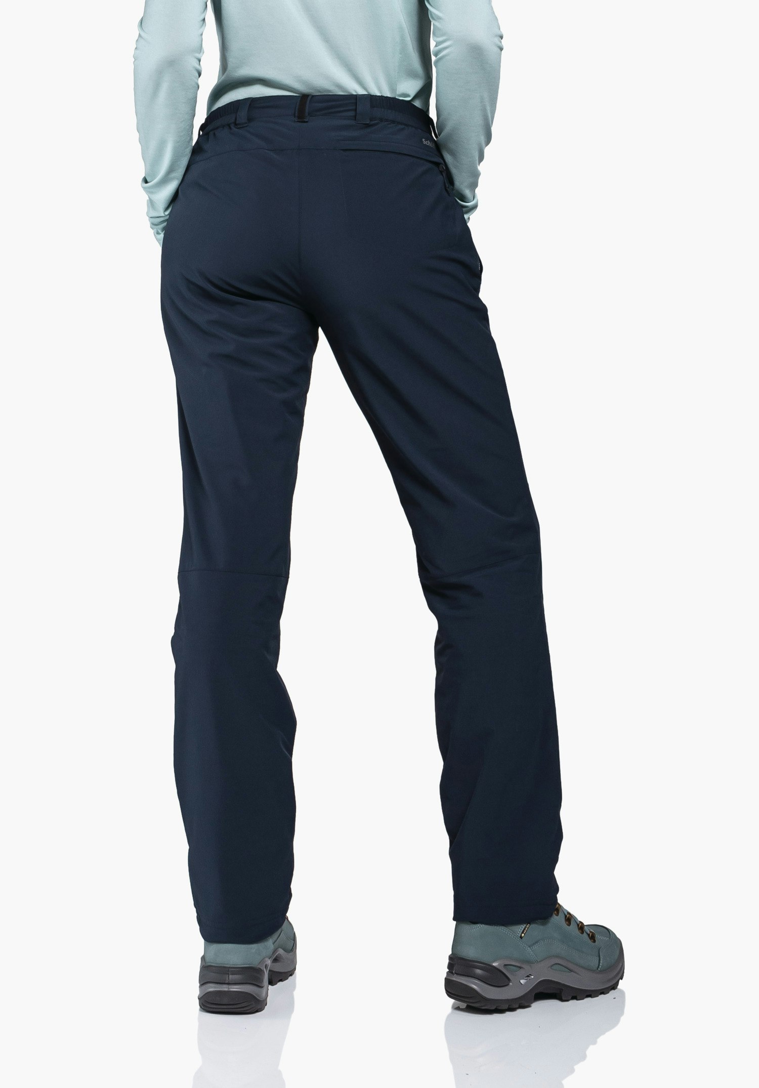 Pants Engadin1 Warm L dark blue outdoor trousers worn from the back by a standing person; context: white background, light blue top, light blue hiking shoes with grey sole. Text on hip: “Schöffel”.