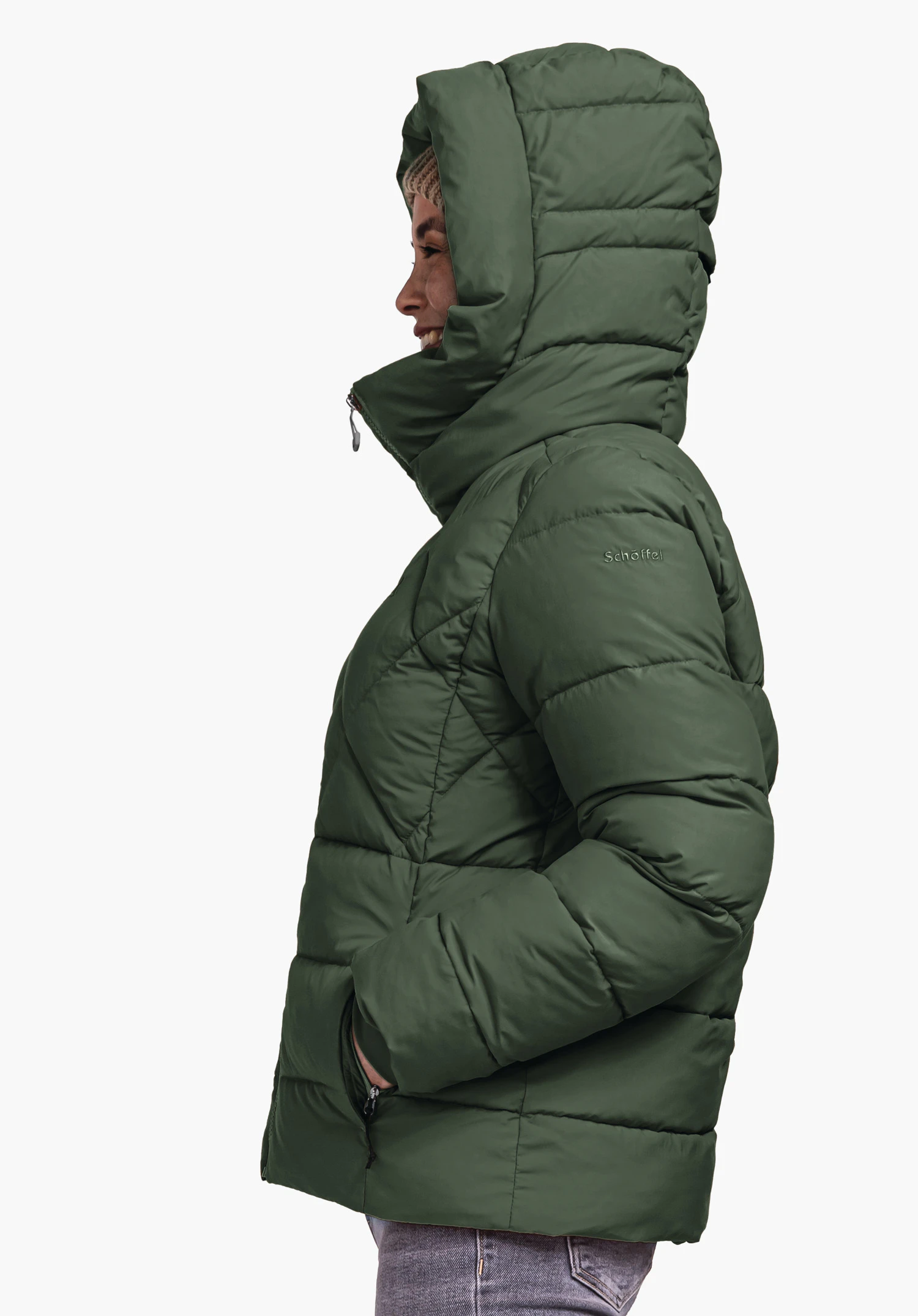 Ins Jacket Boston L dark green quilted jacket worn with raised hood, hands in pockets; side view in front of a light background. Text: "Schöffel".