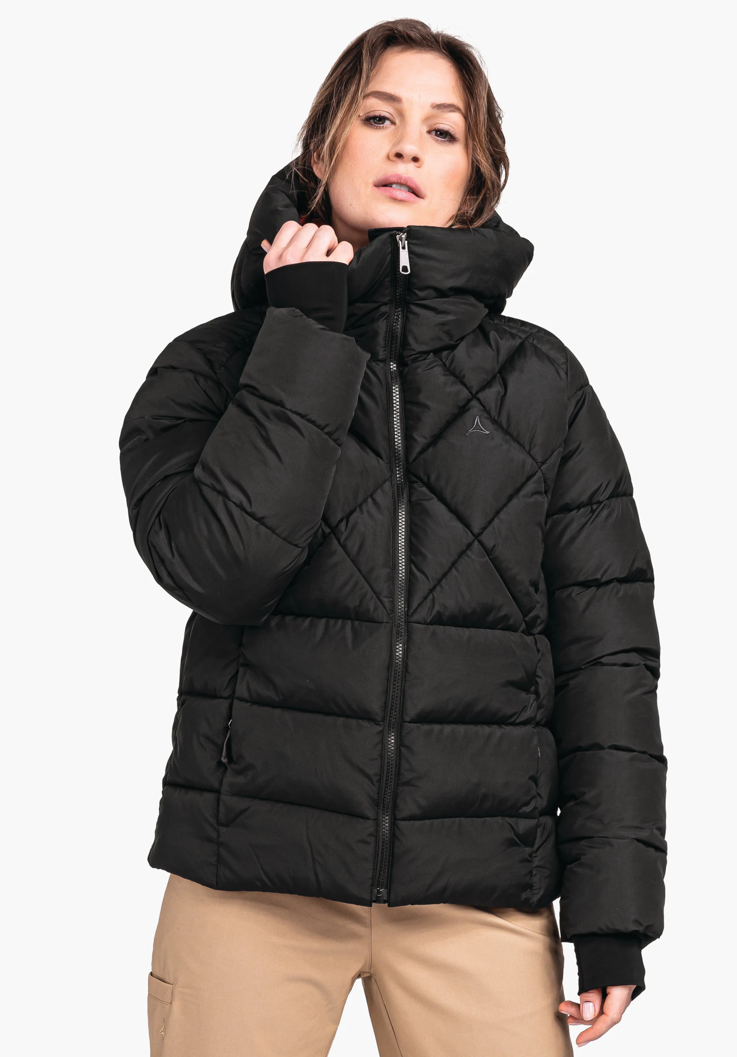 Ins Jacket Boston L black quilted down jacket with Schöffel logo; person pulls the zip up to the neck, standing front-facing against a light neutral background.