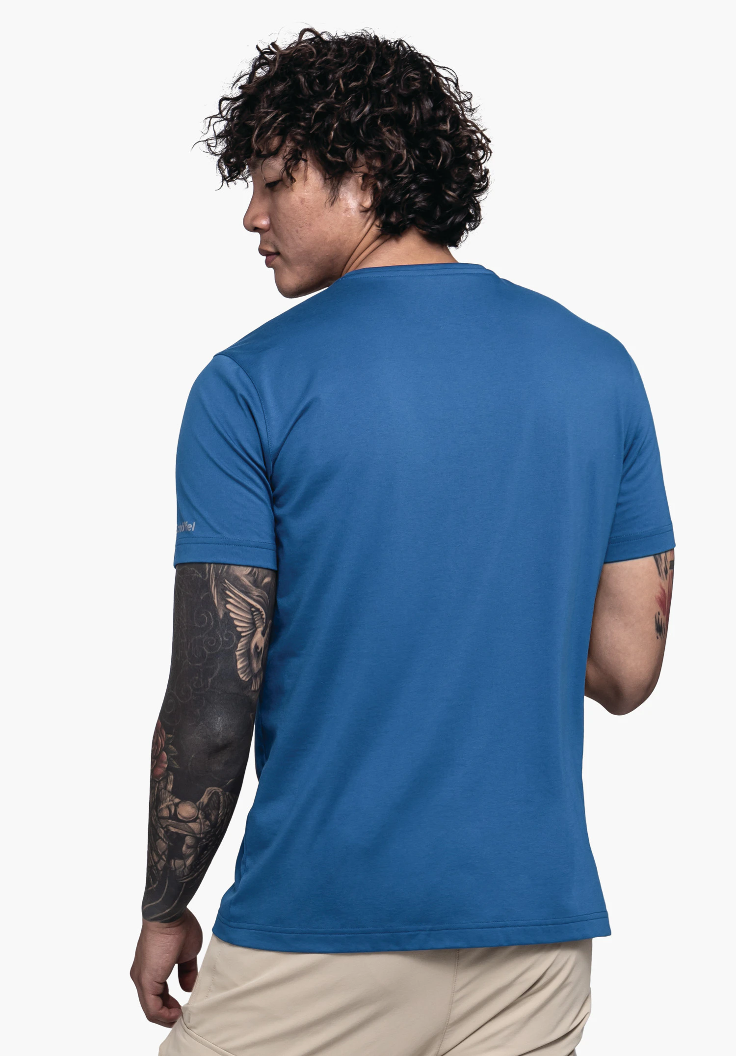 T Shirt Hohberg M in blue. The model is shown from a back view, looking to the side, against a neutral background. A subtle Schöffel logo is placed on the right sleeve.