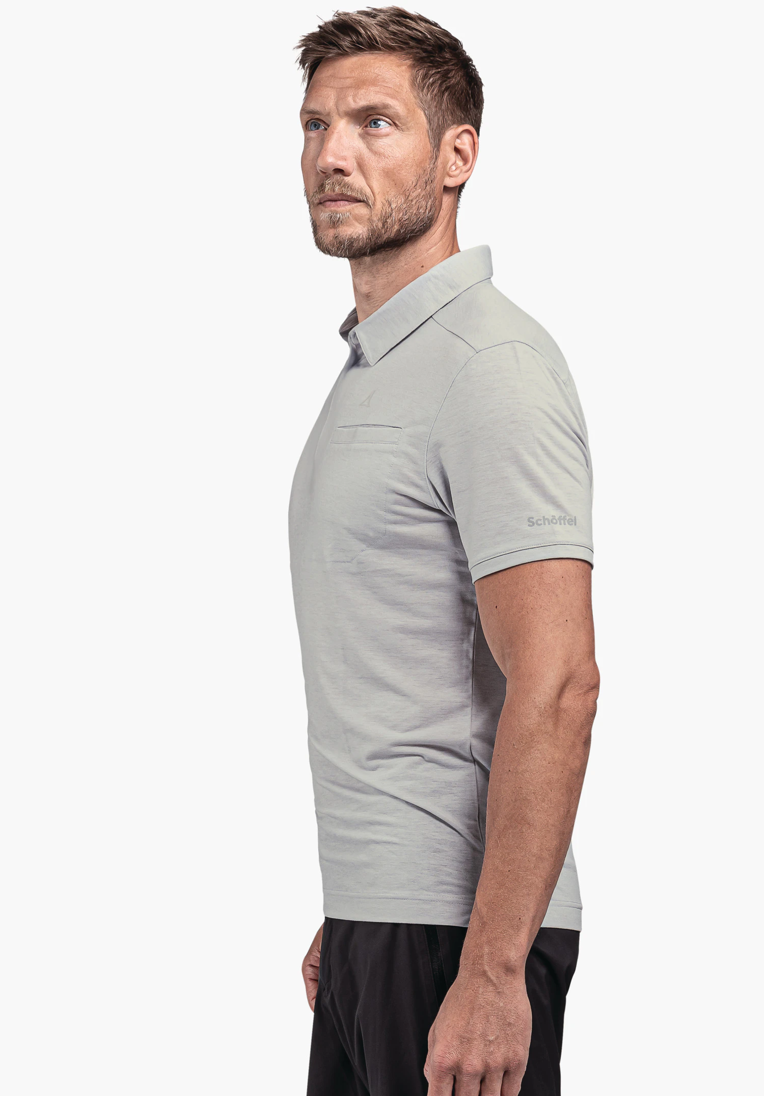 Polo Shirt Ramseck M in grey: The male model is positioned in a side profile against a neutral background. The shirt features a tailored fit and proudly displays the Schöffel logo on the sleeve.