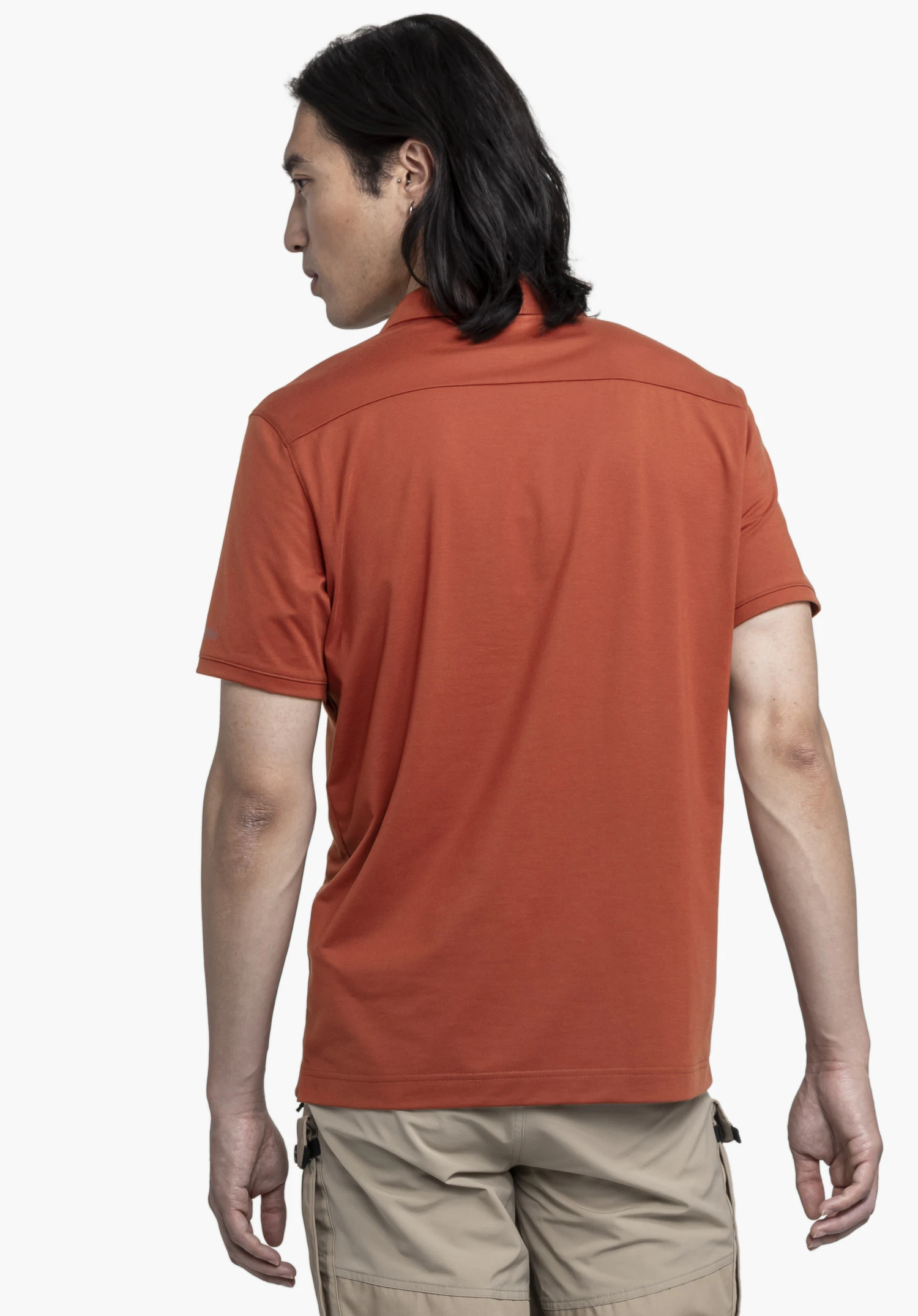 Polo Shirt Ramseck M en rouge, vu de dos devant un arrière-plan neutre. Cette vue met en valeur la coupe ajustée et élégante du polo, tandis que le discret logo Schöffel sur la manche souligne la qualité de la confection.