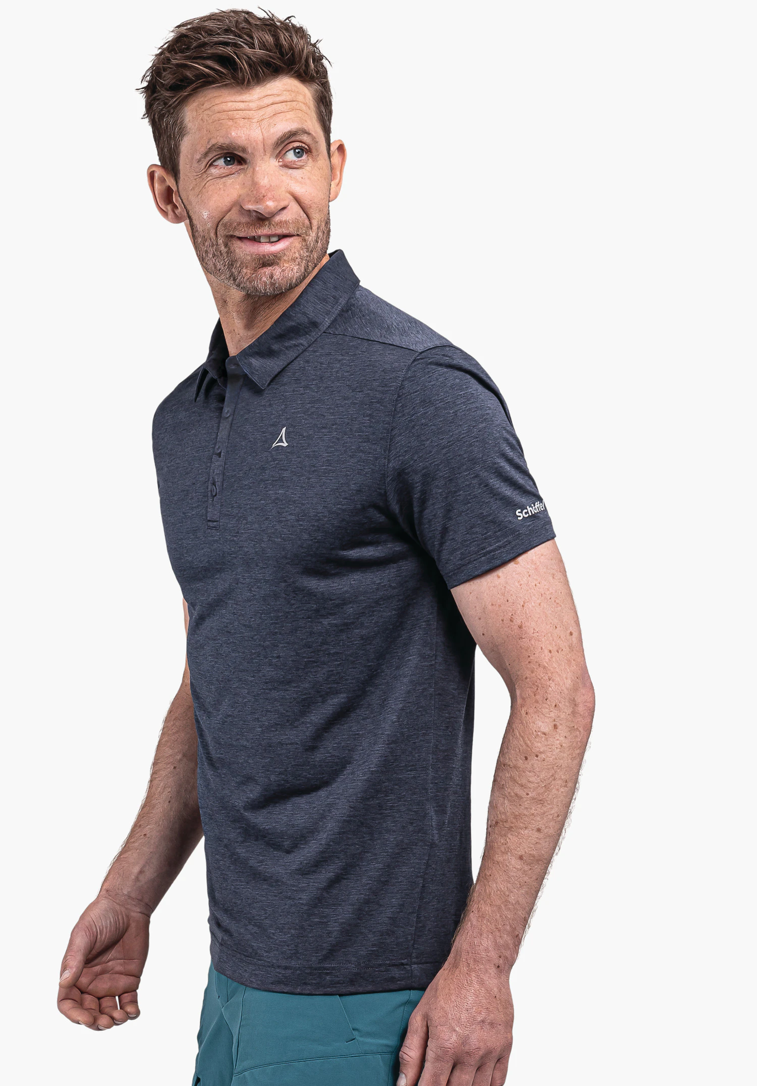 CIRC Polo Shirt Tauron M in blue, worn by a model standing sideways and looking over his shoulder. The Schöffel-Logo is visible on the left chest and sleeve, photographed against a neutral background.