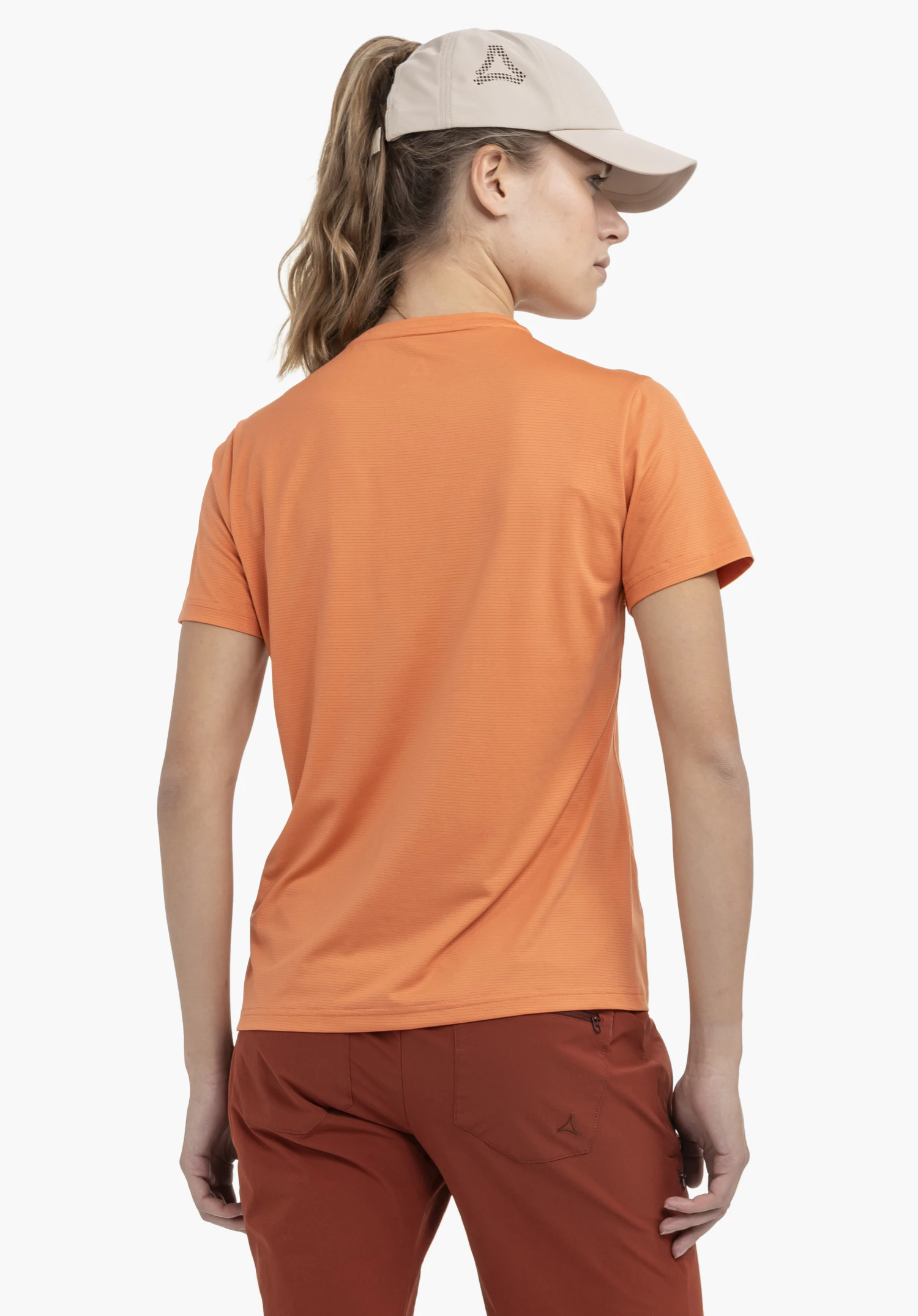 CIRC T Shirt Sulten L in achteraanzicht op een model in de kleur oranje tegen een neutrale achtergrond, waarbij het Schöffel-logo op de broek zichtbaar is.