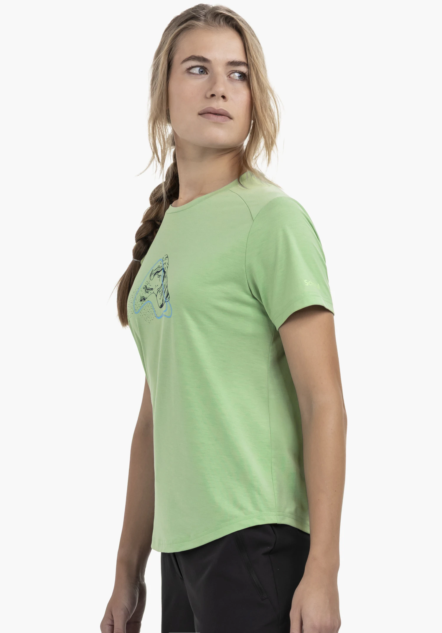 T Shirt Haberspitz L in green, showcased by a model standing sideways and looking towards the camera. The green T-shirt features a subtle Schöffel logo on the sleeve. Captured against a neutral background.