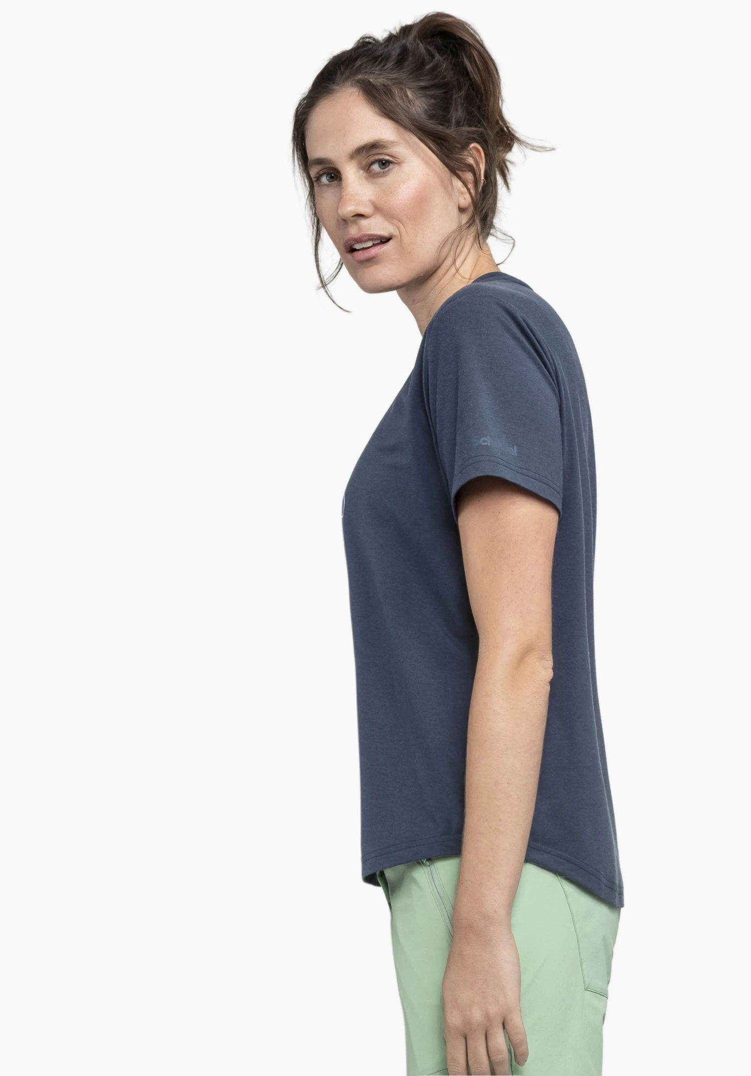 T Shirt Haberspitz L in blue. The model is standing in profile against a neutral background, looking towards the camera. The subtle Schöffel logo is visible on the sleeve.