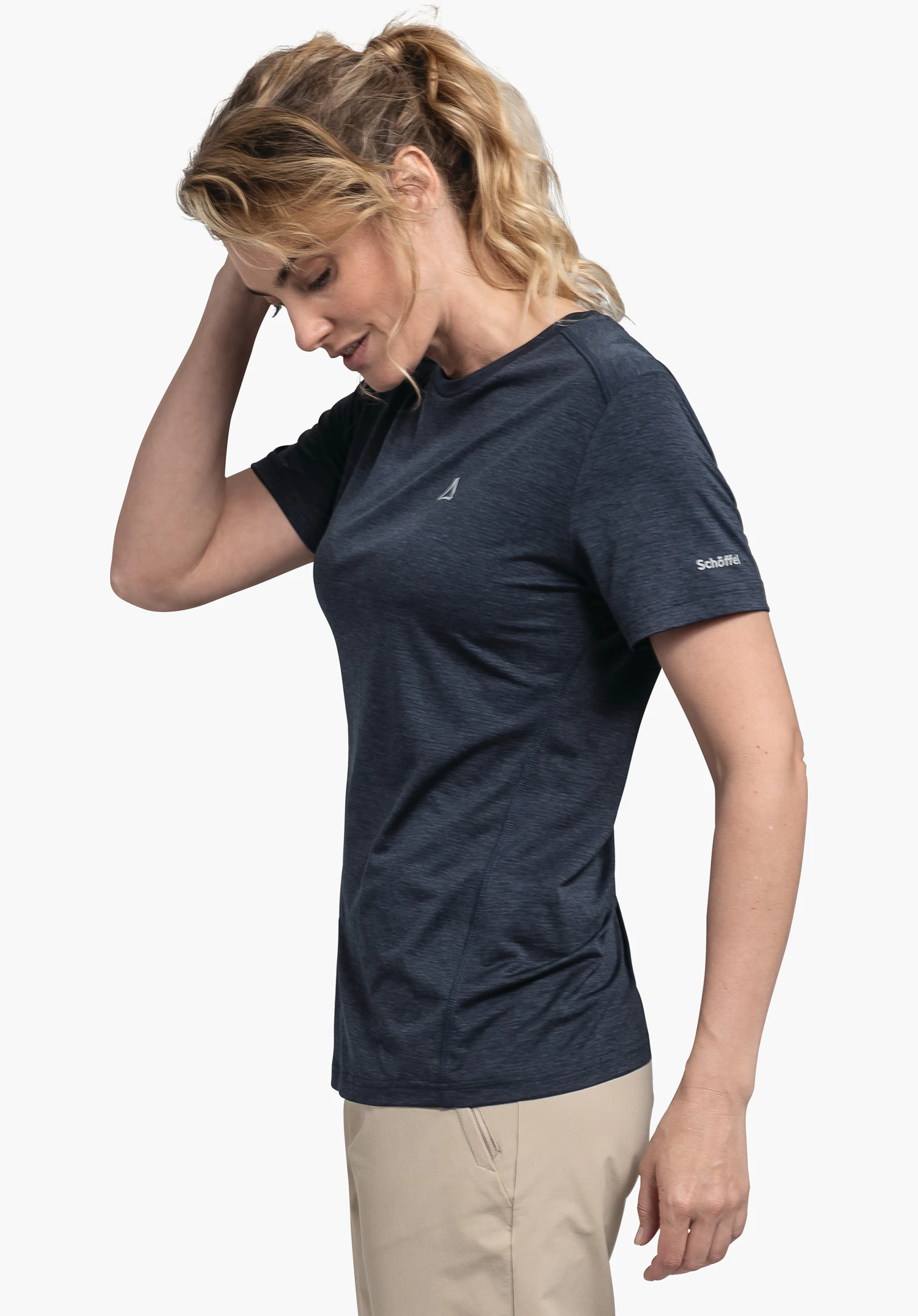 CIRC T Shirt Tauron L dark blue T-shirt worn by a woman placing her hand on her head; Schöffel logo on chest, lettering "Schöffel" on sleeve; light studio background.
