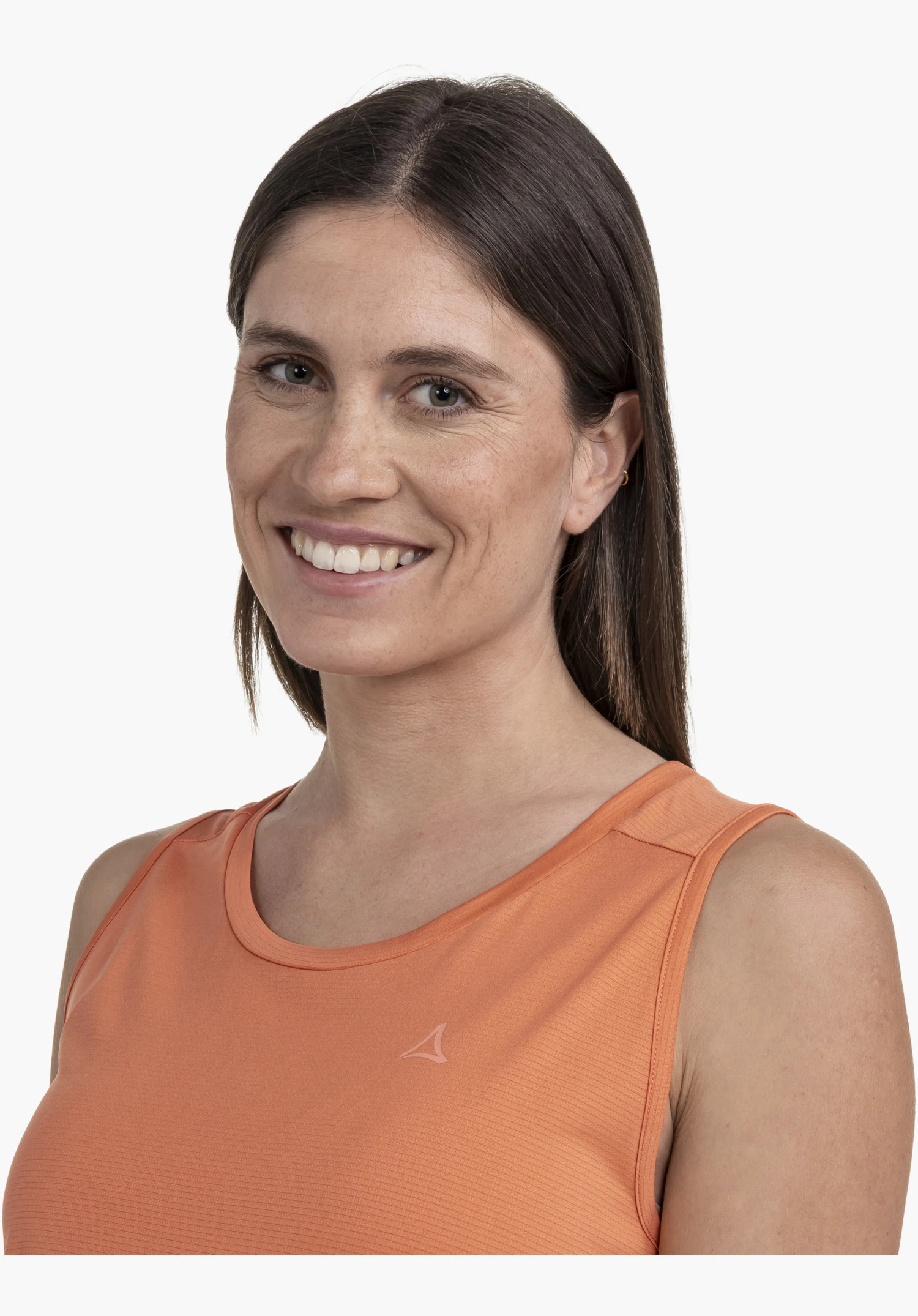 CIRC Top Tauron L in orange. A model stands facing the camera, wearing the top with a visible Schöffel logo on the chest against a neutral background.