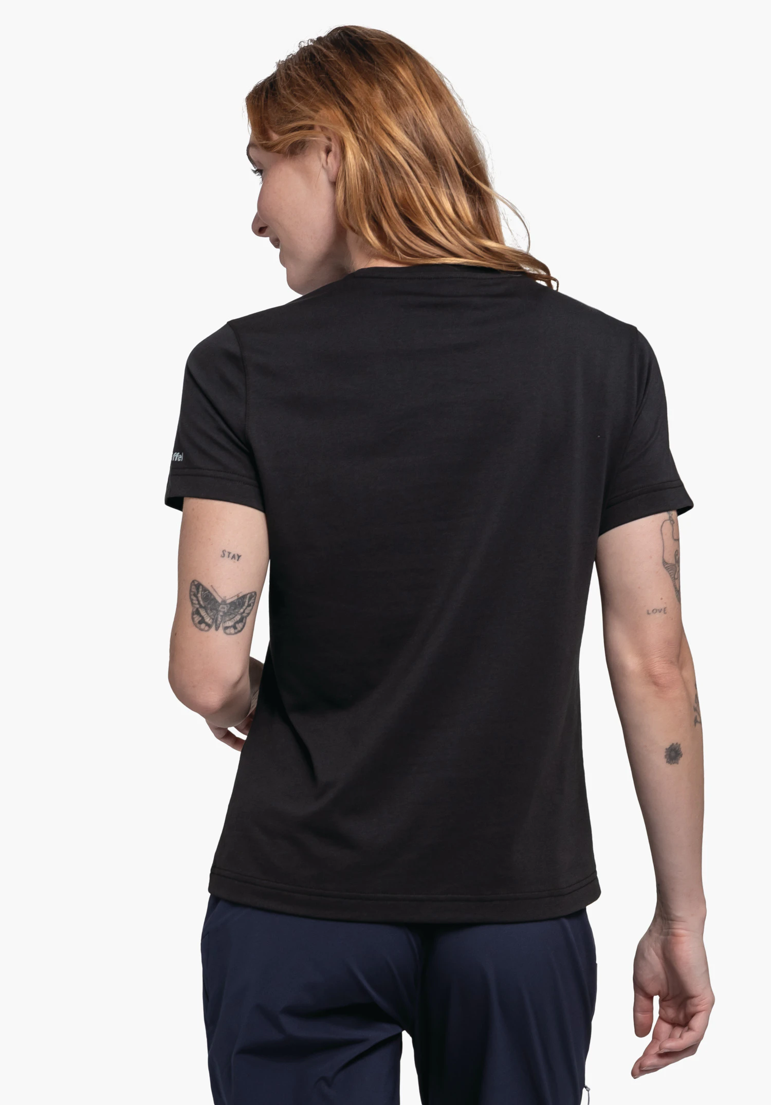 T Shirt Hohberg L worn by a model in a back view. The black shirt features the Schöffel logo on the left sleeve. The model stands in front of a neutral background.
