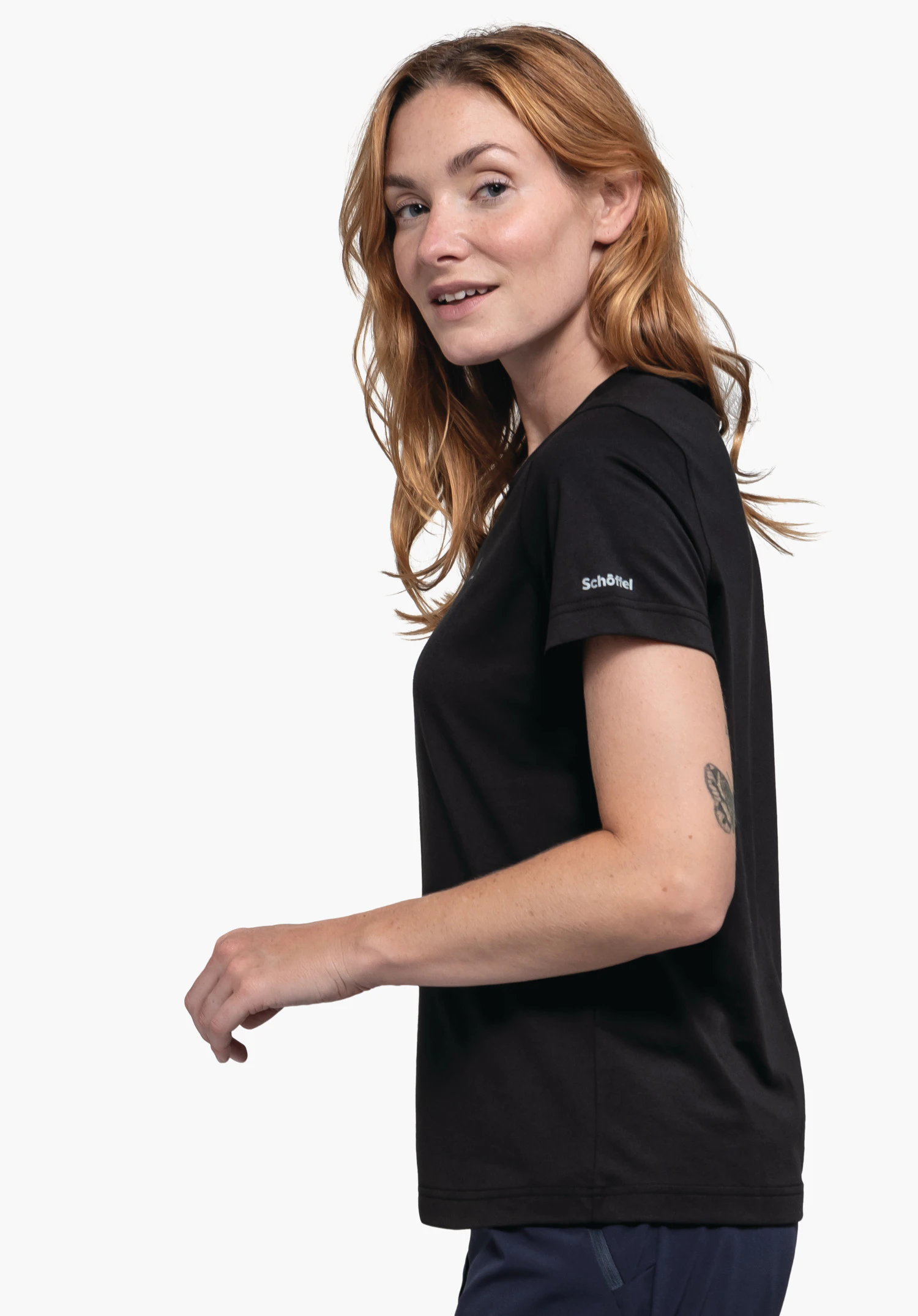 T Shirt Hohberg L in black worn by a model standing sideways. The Schöffel-Logo is visible on the left sleeve, photographed against a neutral background.